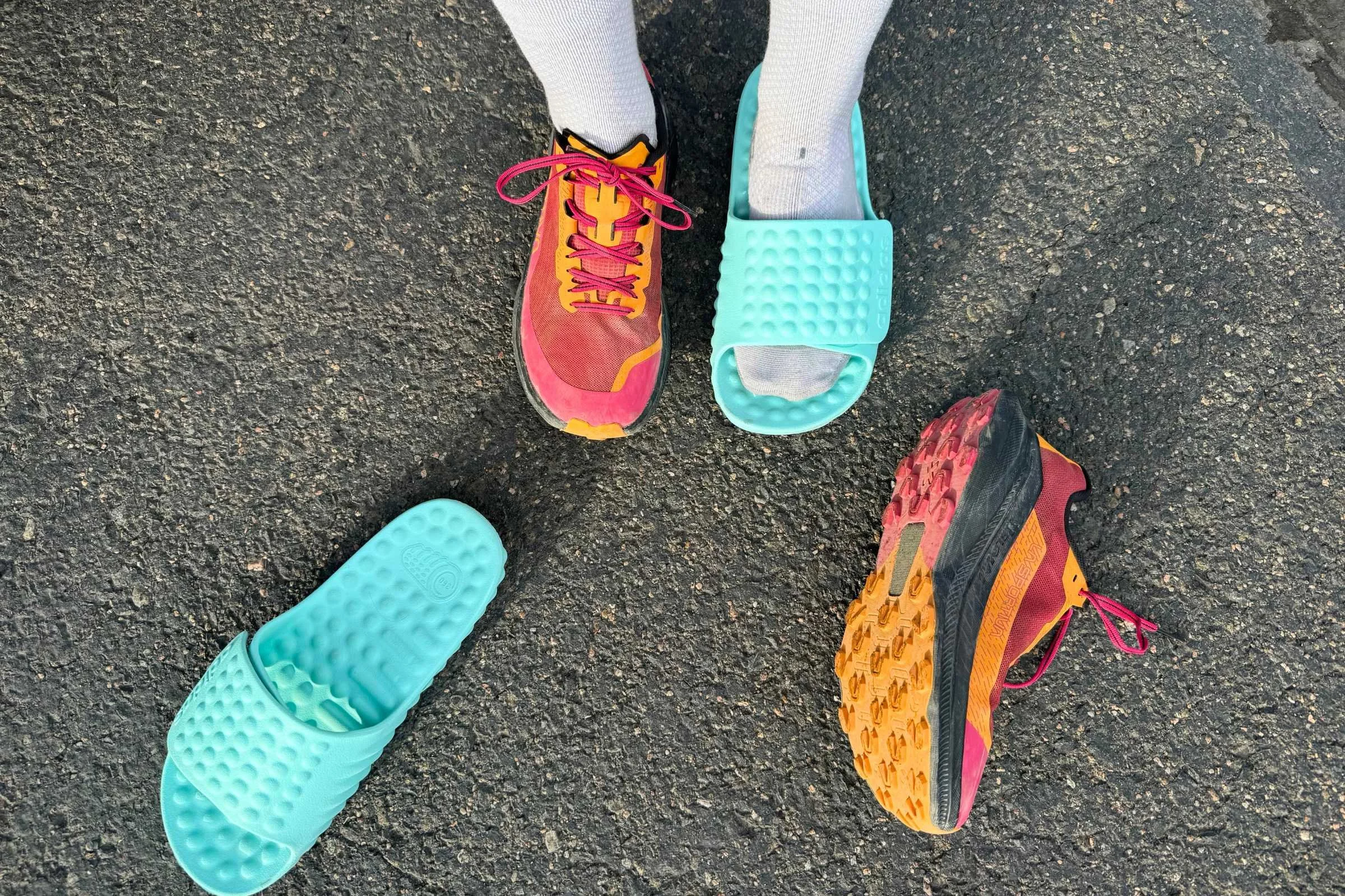   Person wearing an Adidas Adissage 360rec Slide on one foot and a running shoe on the other  