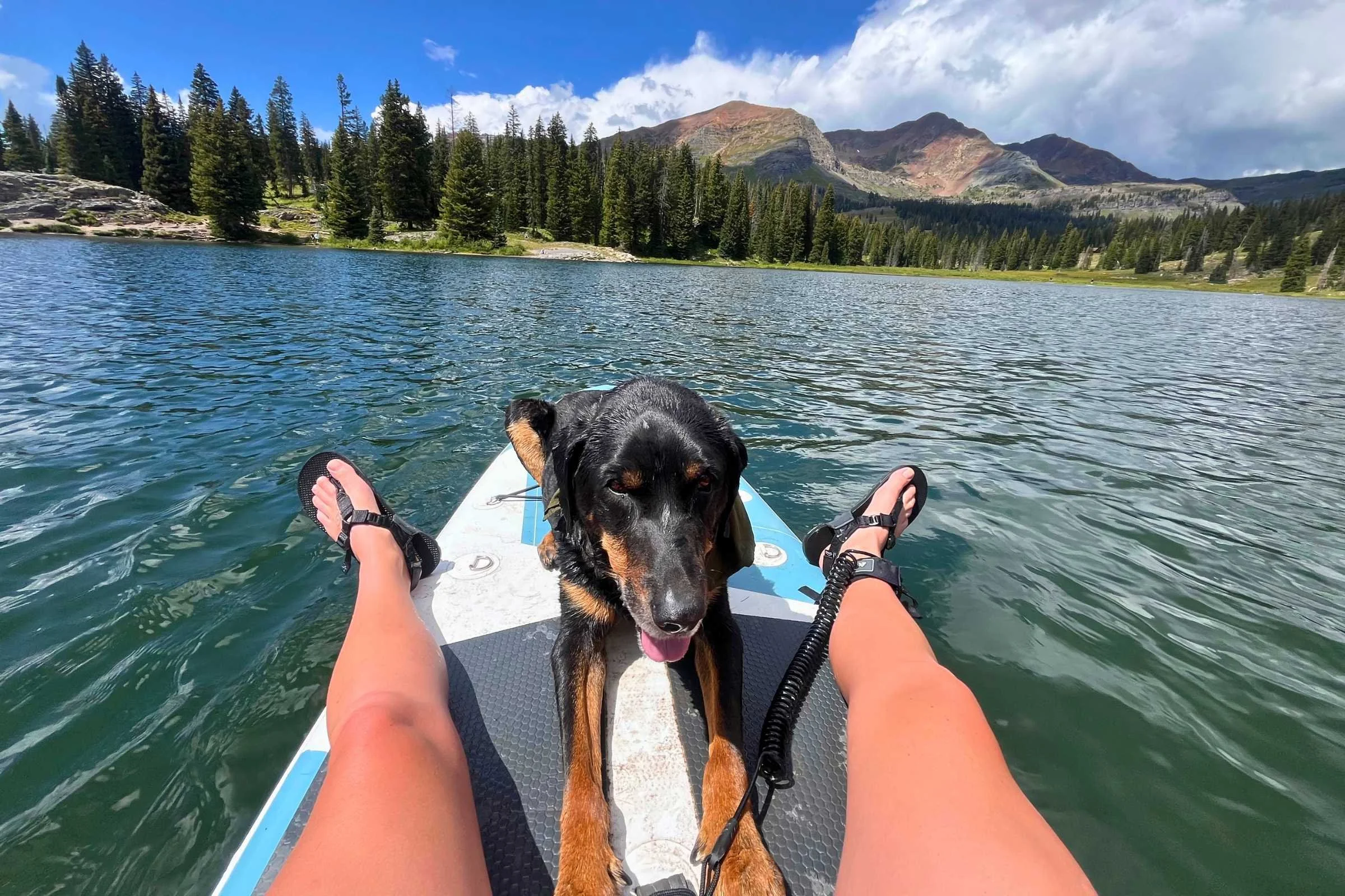   The author paddling while camping near an alpine lake with her best friend in the Bedrock Cairn sandals.   Photo by Stasia Stockwell.  