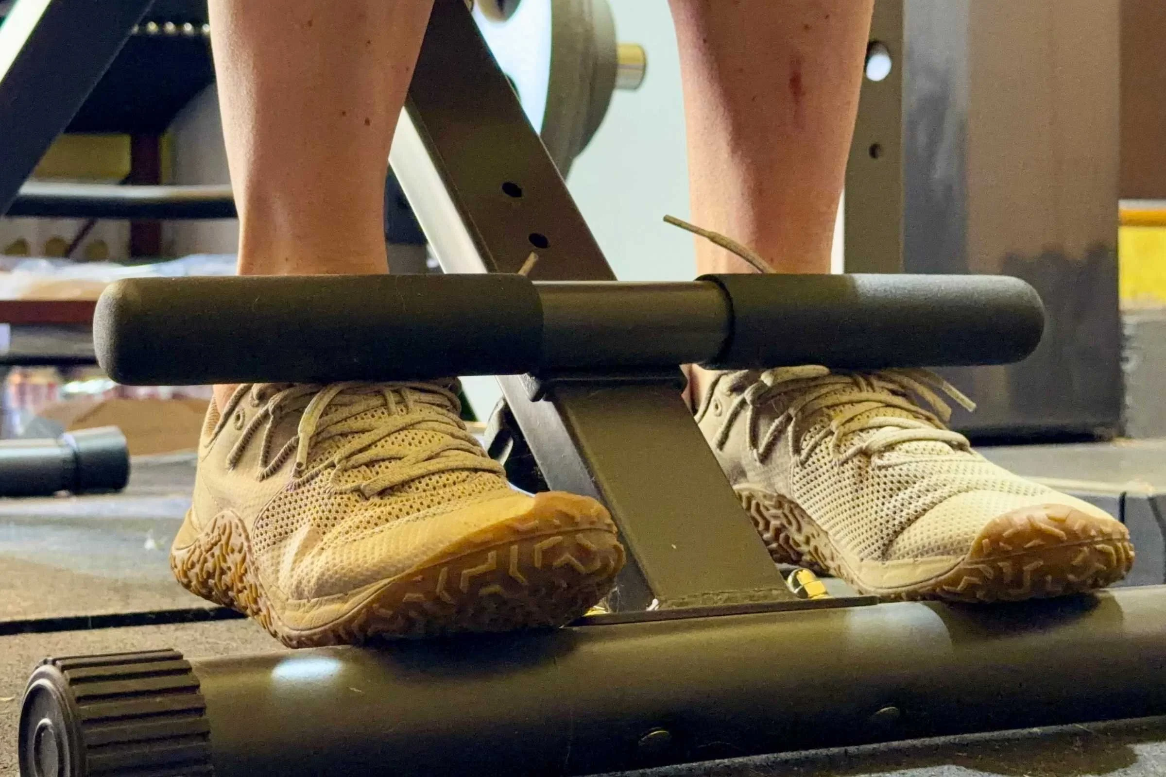   Merrell Trail Glove 7 barefoot shoes on footrests of gym equipment during workout  
