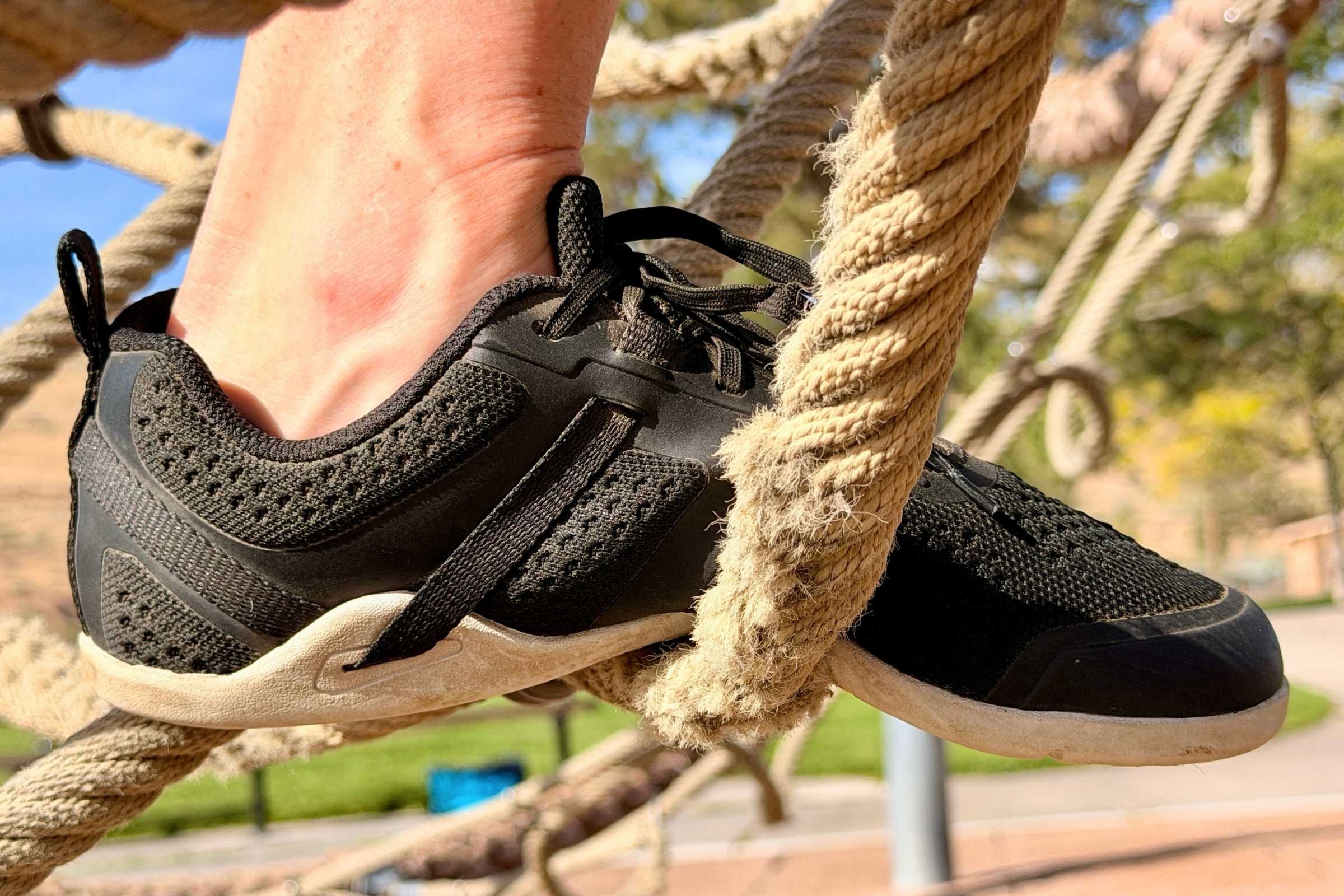   Xero Shoes Prio Neo worn while balancing on a rope obstacle  