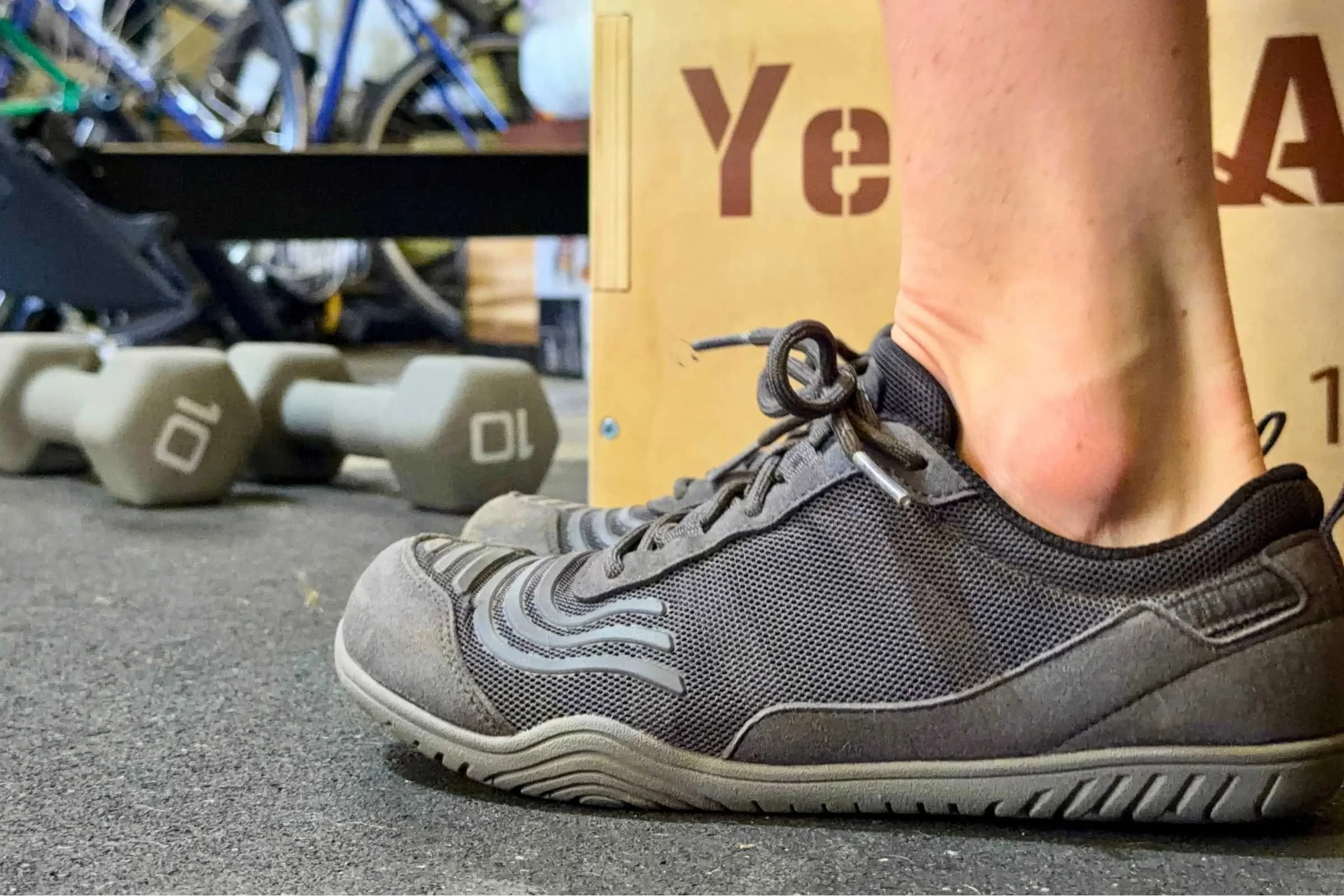   Side view of Xero Shoes 360 barefoot shoe in a gym setting  