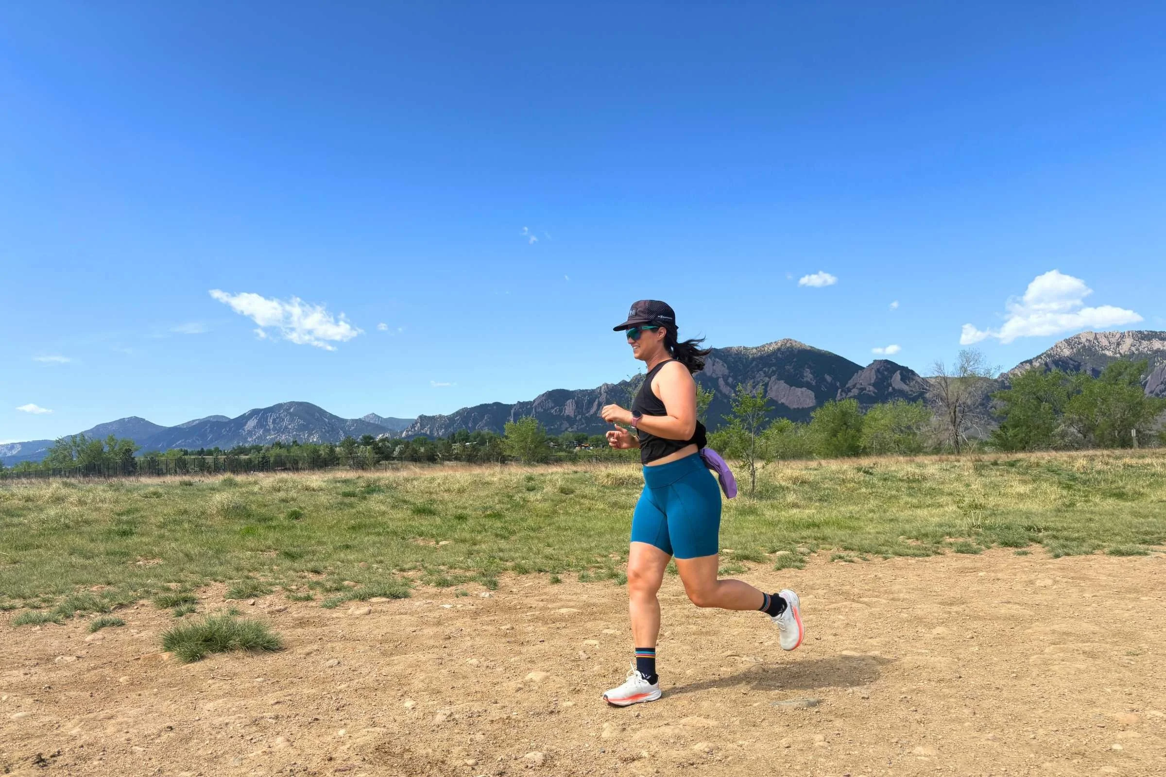   Tester running on a dirt path in the Janji Pace Running Shorts  