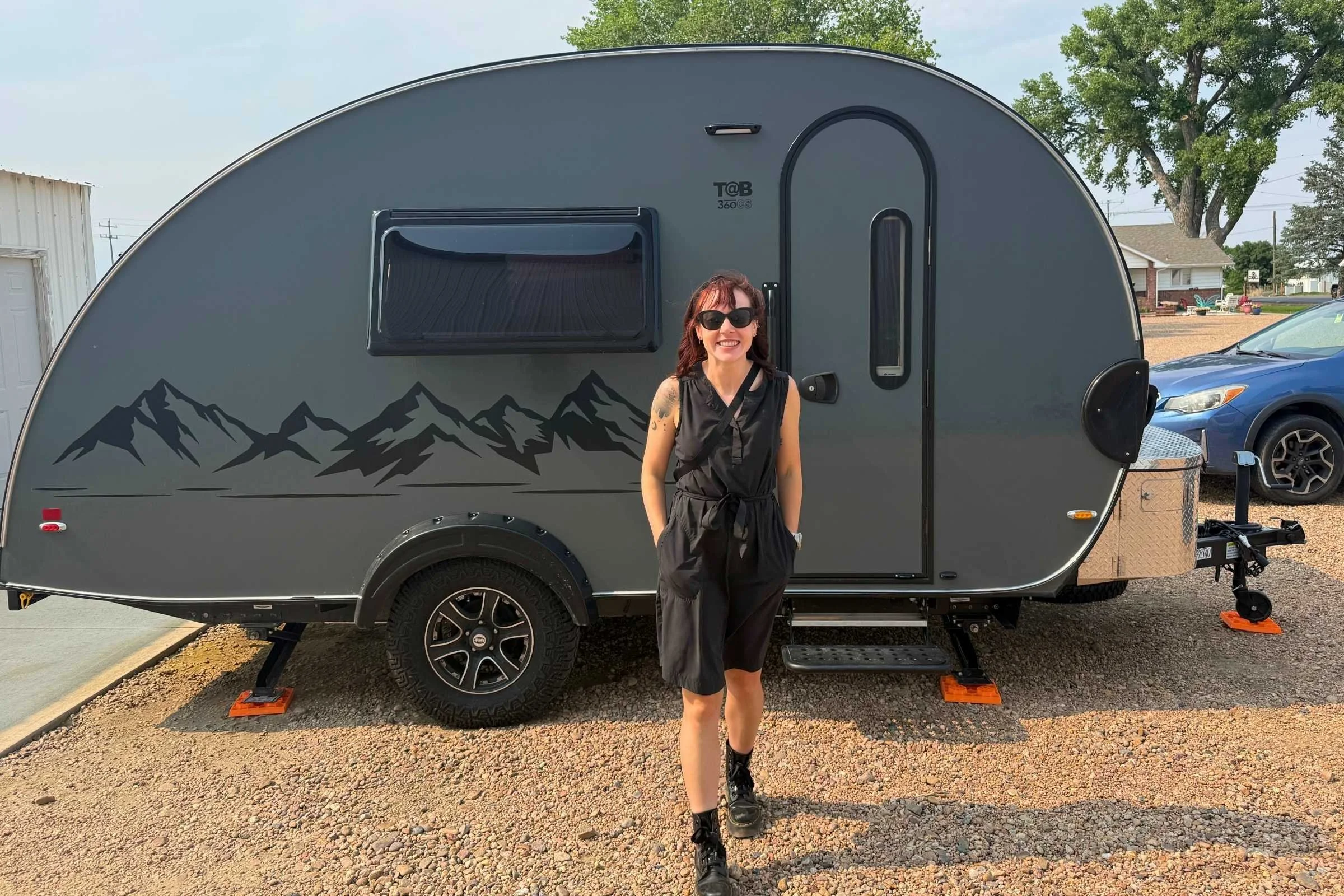   Standing with a teardrop camper in the Royal Robbins Spotless Traveler Tank Dress  
