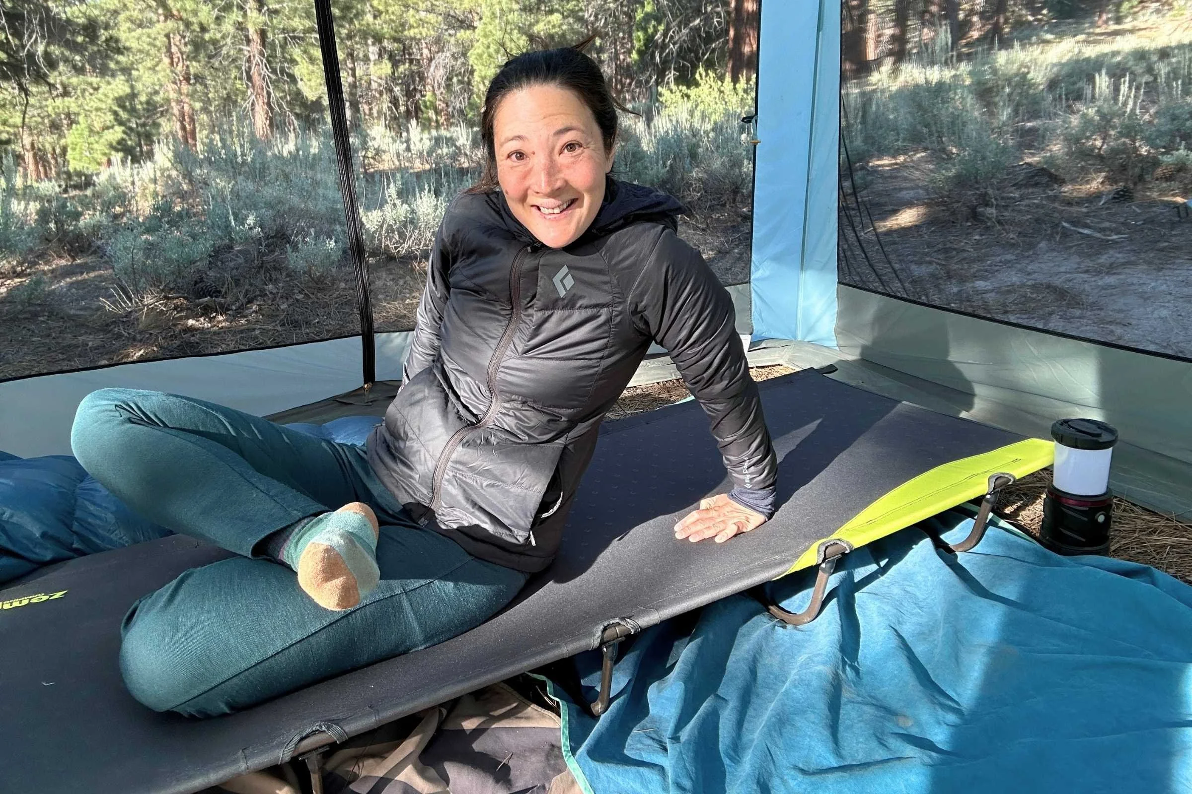  The author Liz Thomas on a Zempire W Leg Stretcher V2 inside a tent. 