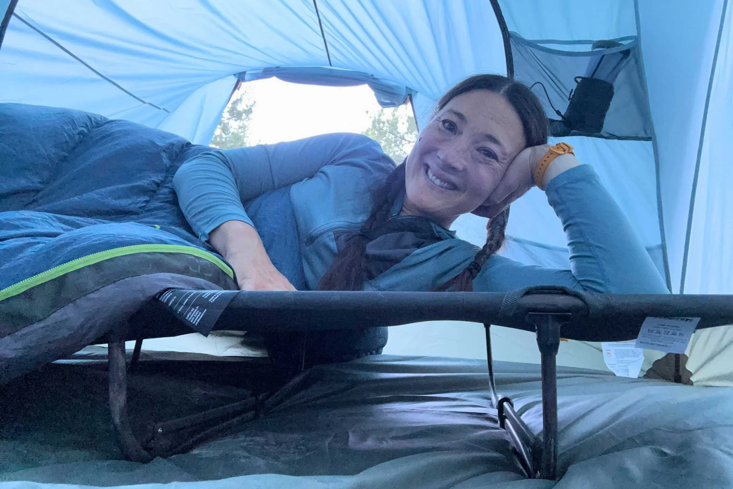  The author reclining and testing a Zempire W Leg Stretcher V2 inside a tent. 