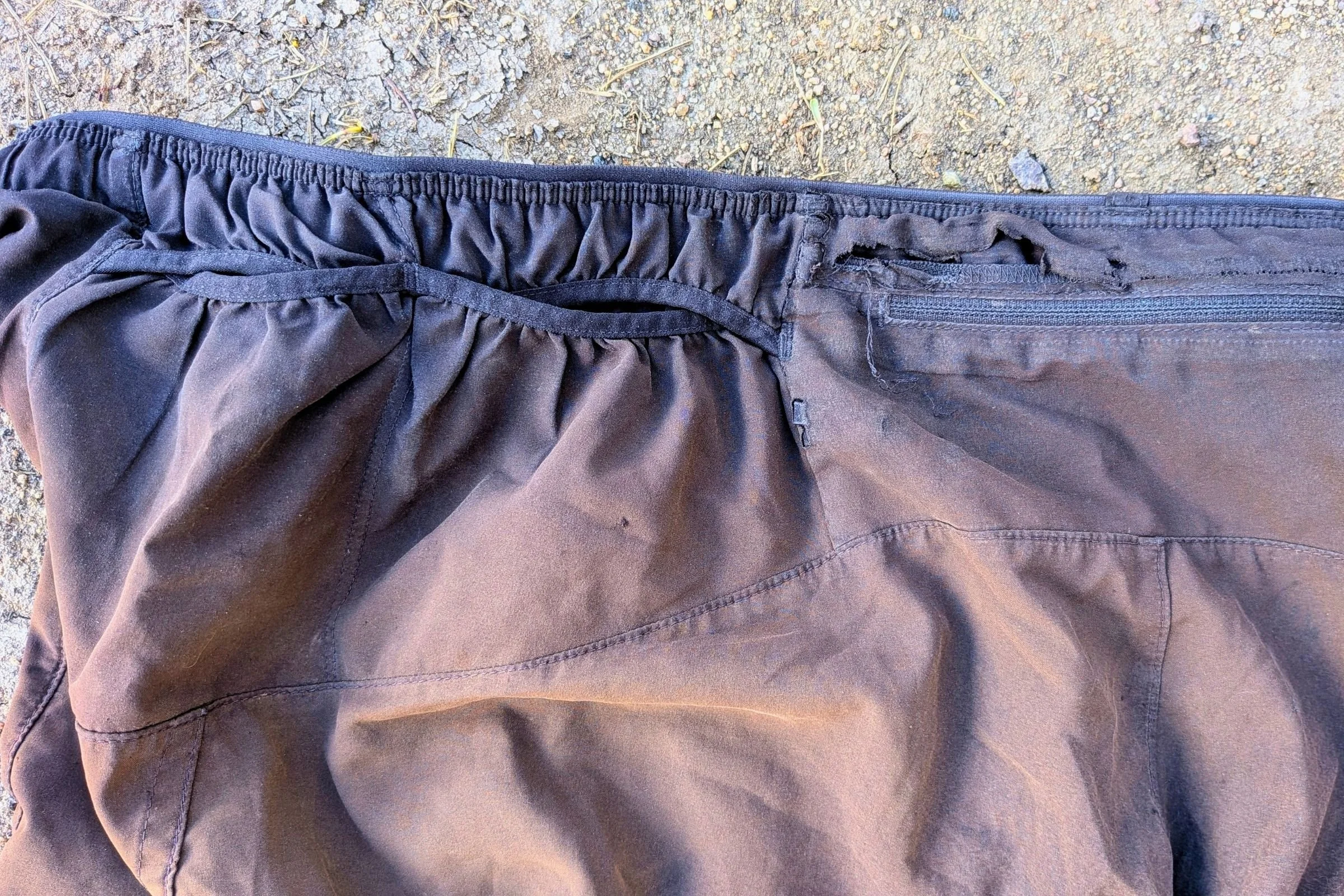   A closeup of the external hip pockets on the Patagonia Strider Pro shorts, and the faded black patina earned through miles under the hot sun  