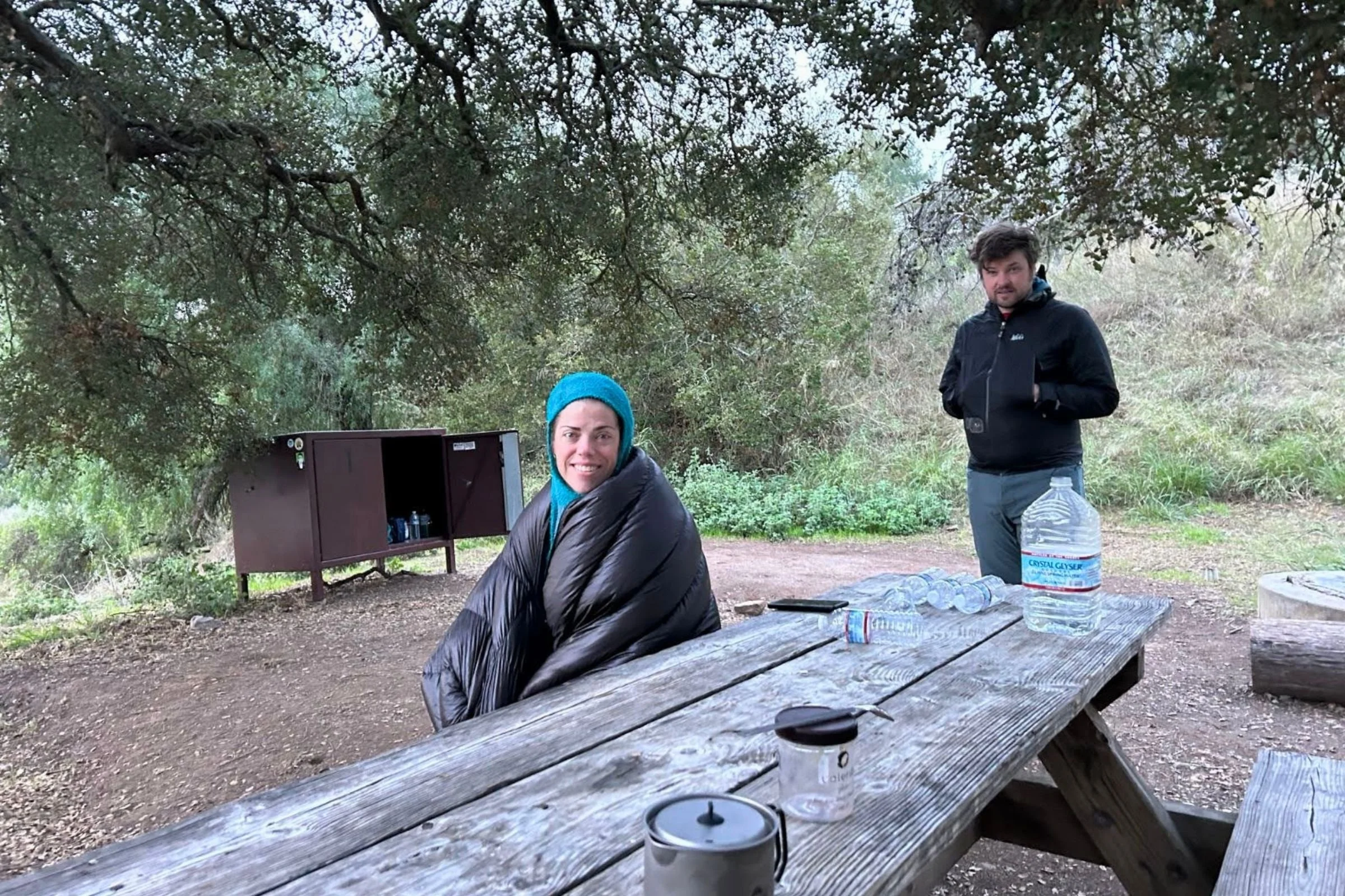   Treeline Review writer Kate Hoch keeping warm in the Zpacks quilt on a January hike of the Trans Catalina trail.   Photo by Kate Hoch  