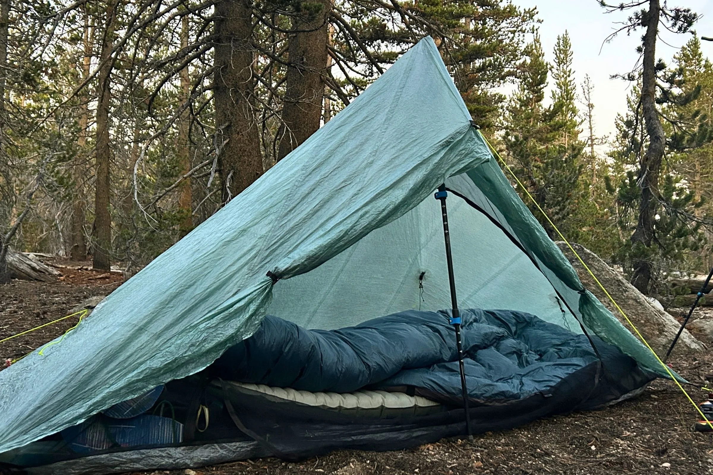   The Outdoor Vitals StormLoft Down TopQuilt set up inside a lightweight shelter, showing its generous loft and full-length quilt design.  