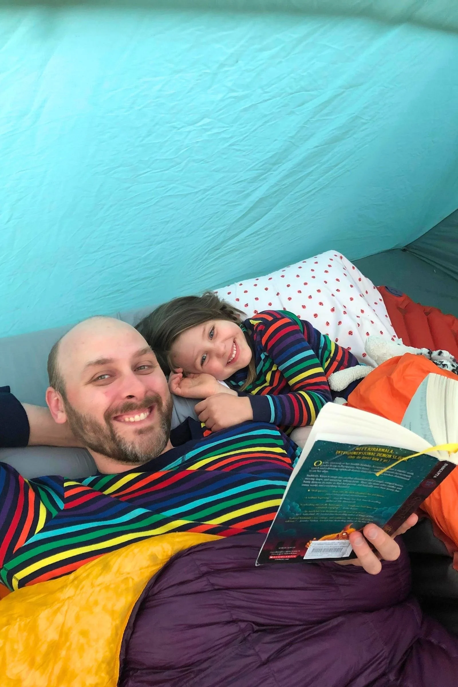   The author’s husband snuggling with his favorite hiking partner in the Enlightened Equipment Accomplice.   Photo by&nbsp; Tiffany Searsdodd  
