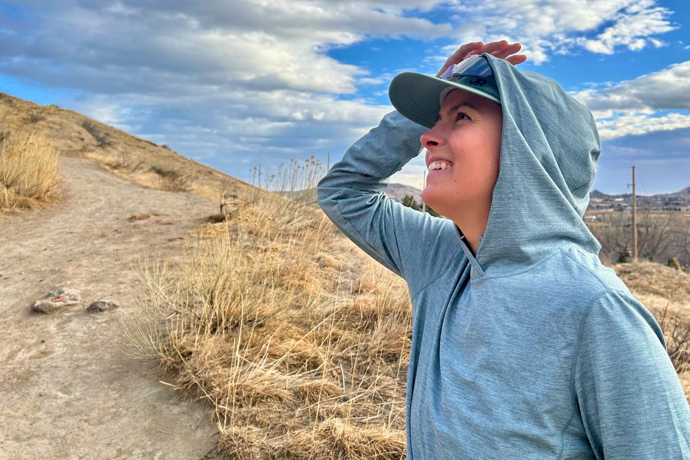   Close-up of a runner wearing the Patagonia Capilene Cool Sun Hoody with the hood up.  