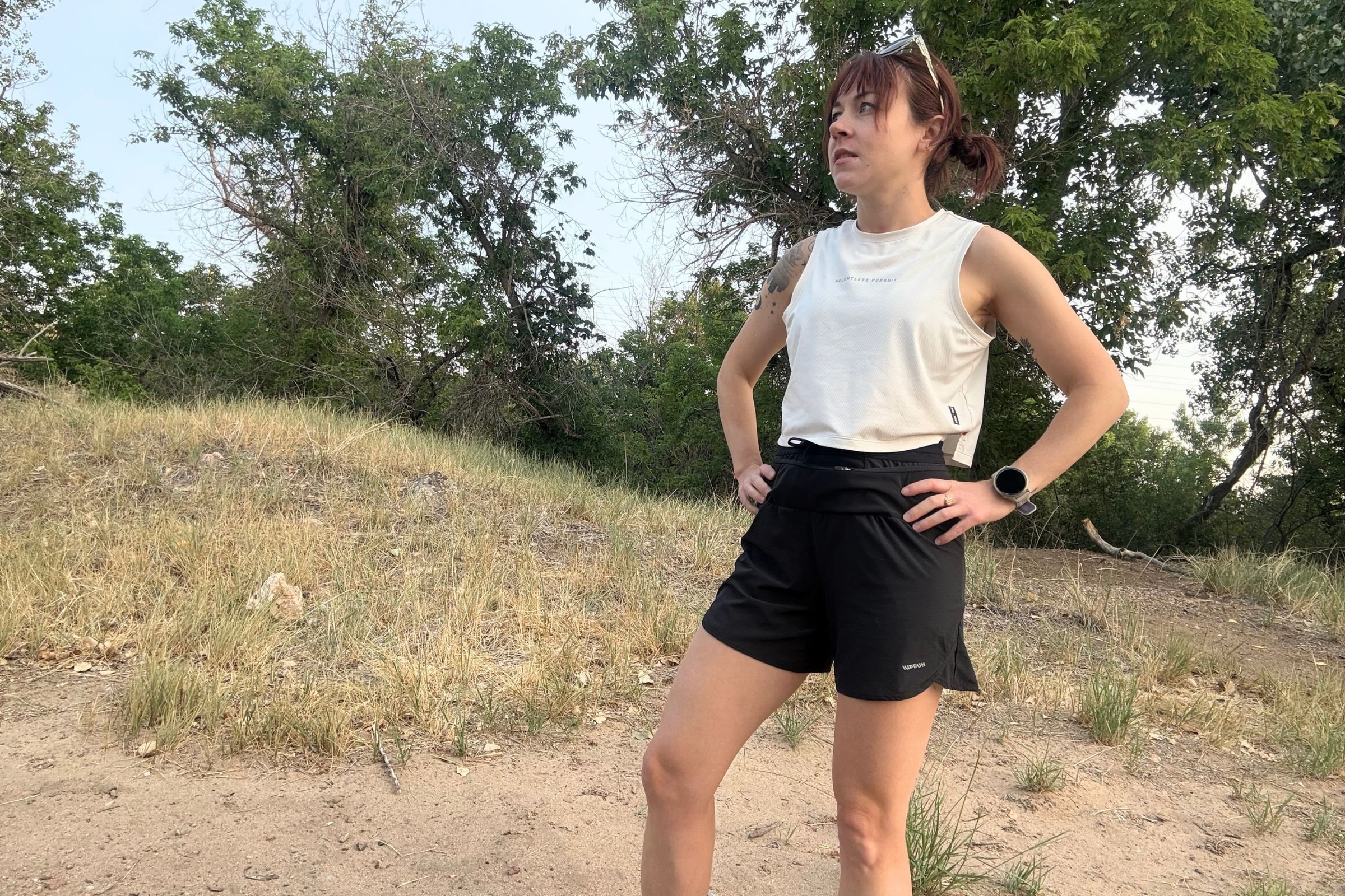   A runner wearing the ASRV x Equinox Aerosilver Cropped Training Tank, showing its cropped fit.  