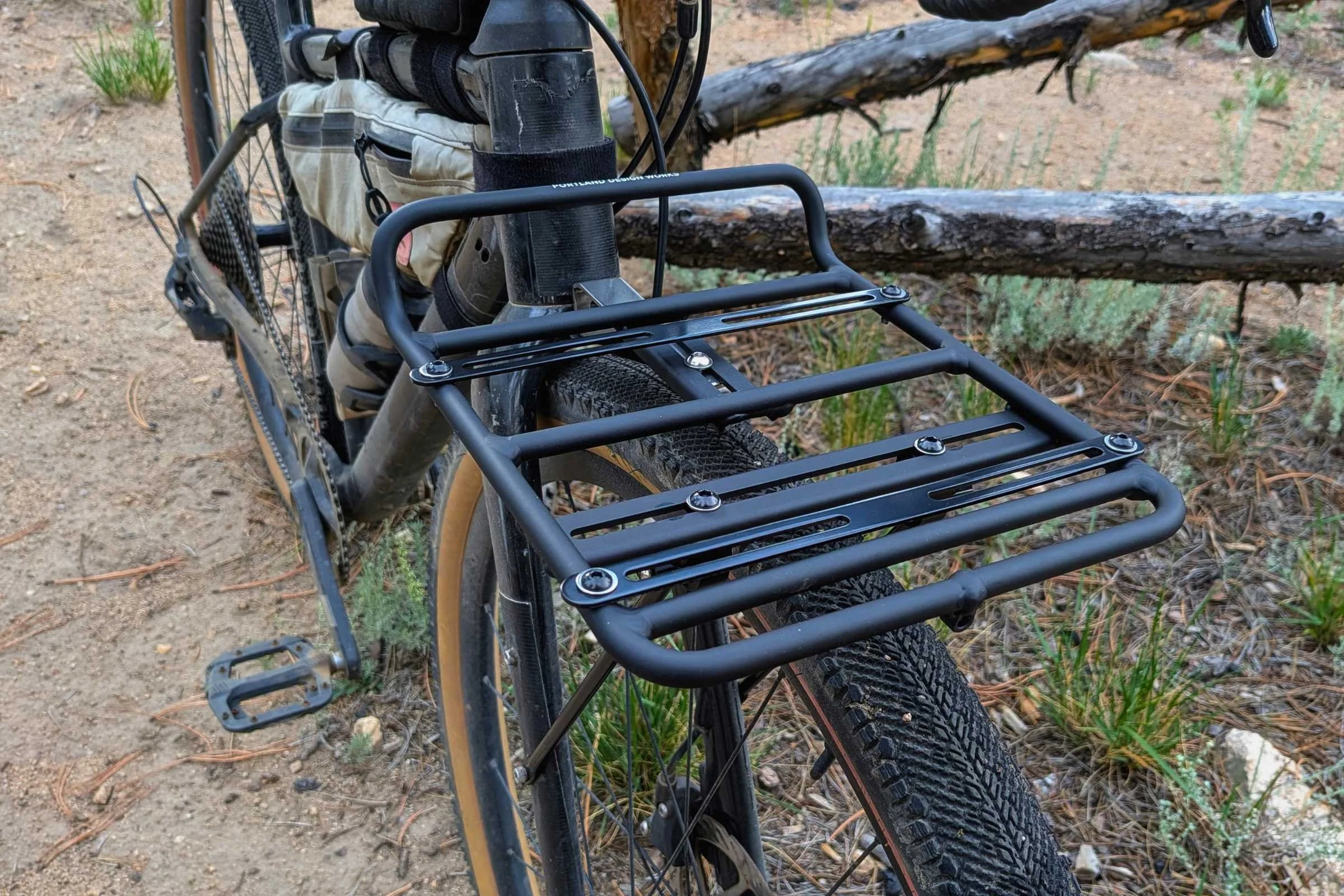   The Portland Design Works OxRack Front Rack is mounted to a bike, showing its wide cargo platform and integrated basket-support struts.  
