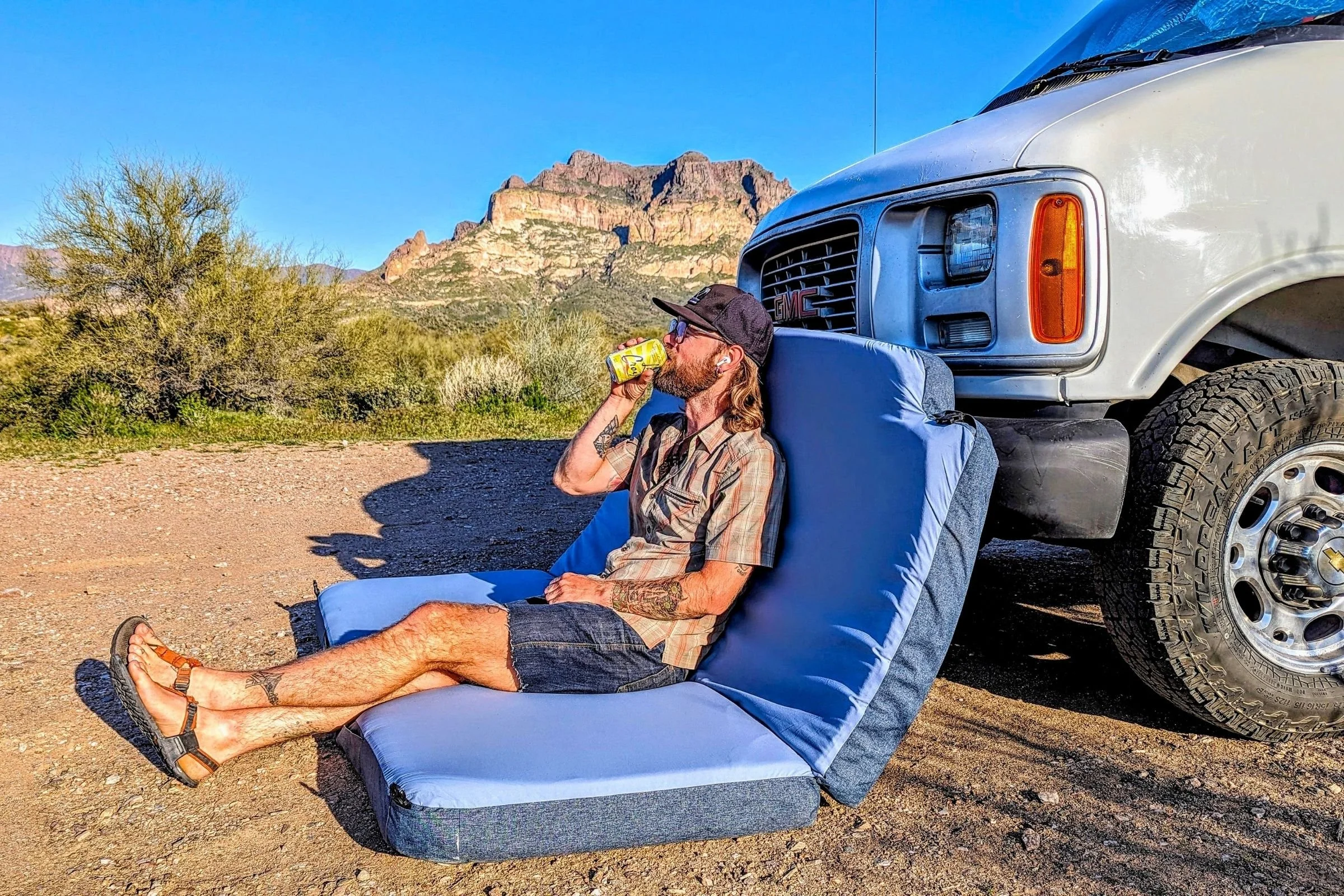   The HEST Dually folds into a comfortable lounge chair beside a vehicle, showing how its design can double as a couch when you're not sleeping.  