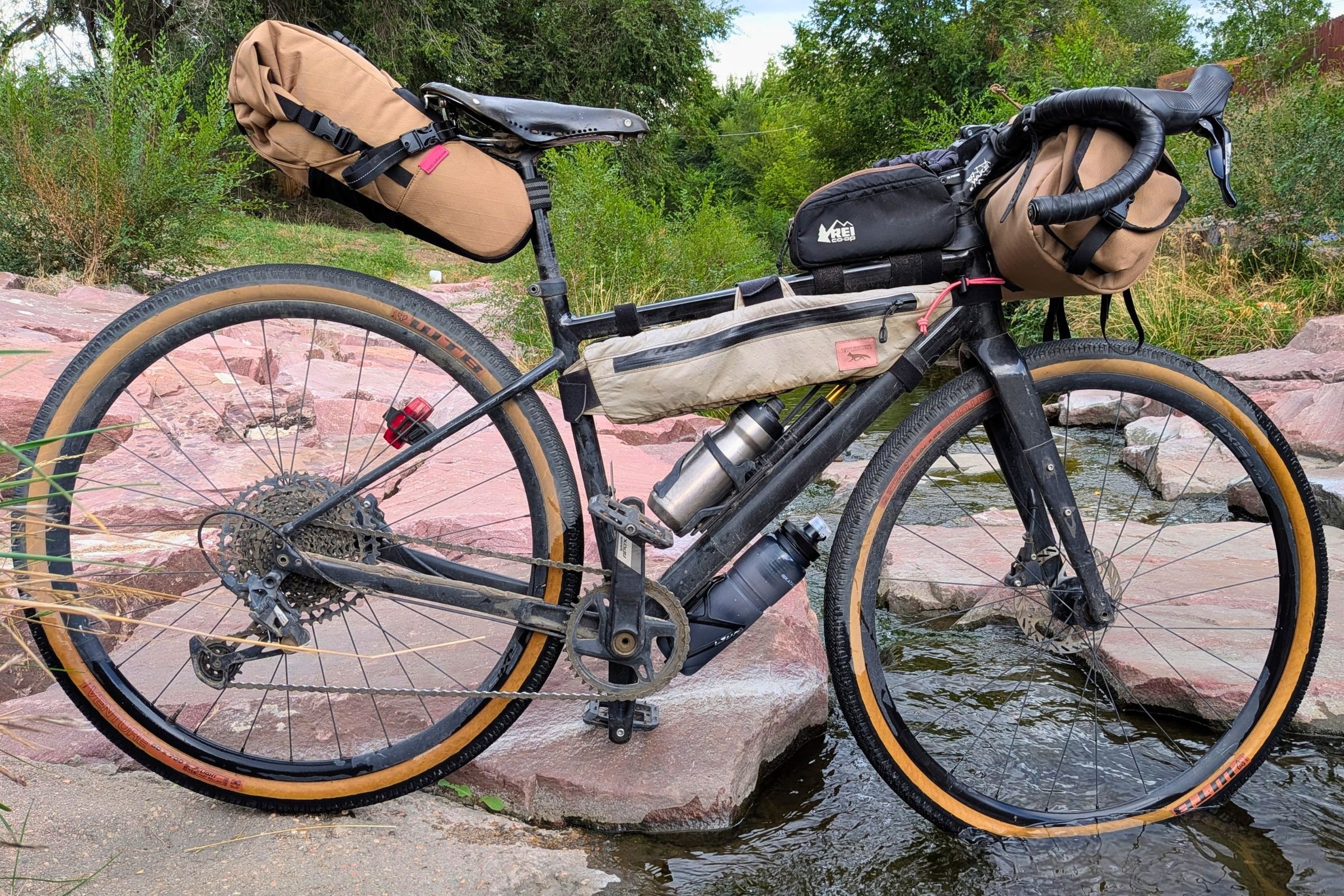   The Katadyn BeFree AC Bottle sits in a bike’s bottle cage, showing its hard-sided design and compact profile for carrying filtered water on rides.  