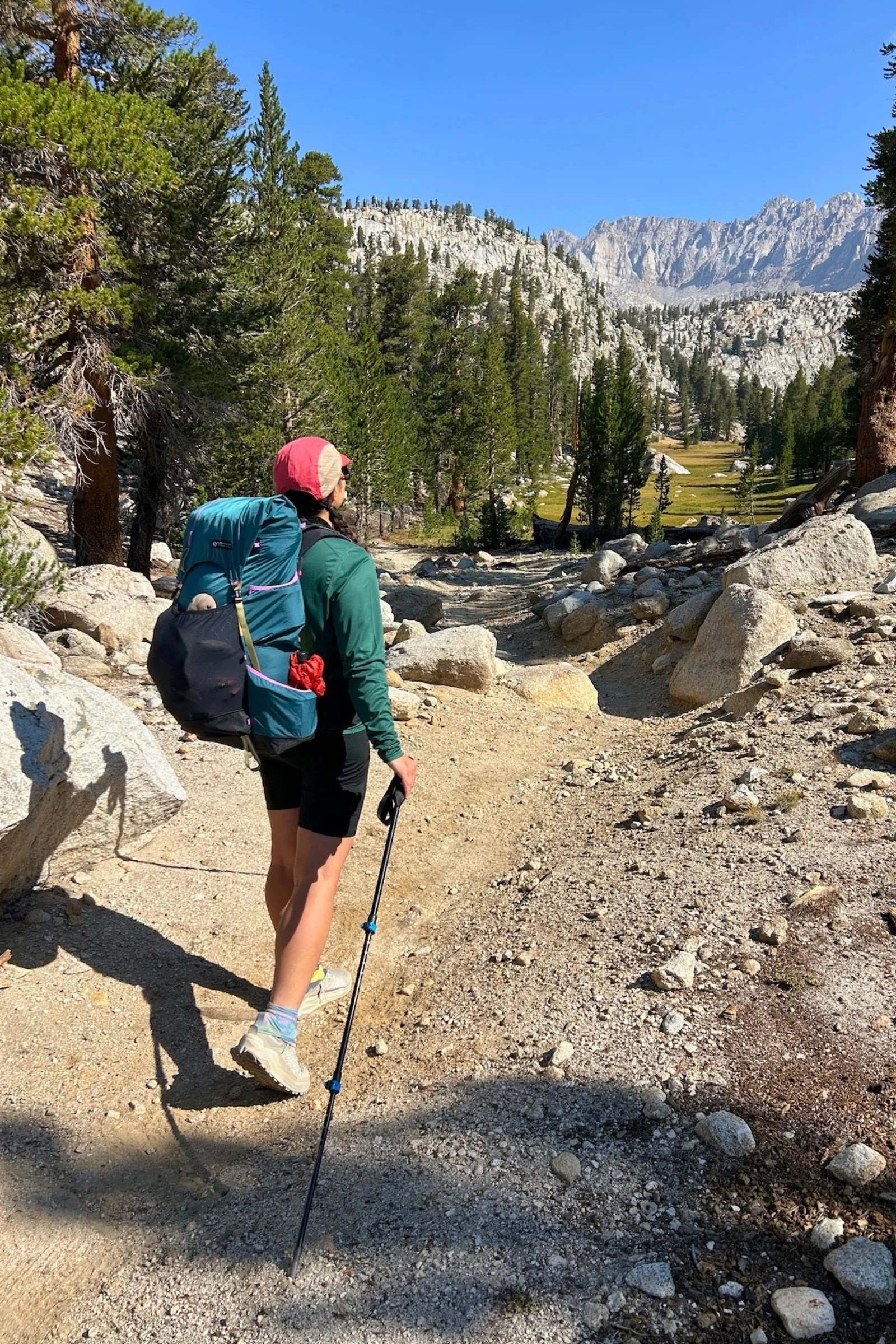   The Gossamer Gear Mariposa 60 carries a full load on a rocky mountain trail, with its padded shoulder harness and hip belt helping distribute the weight.  