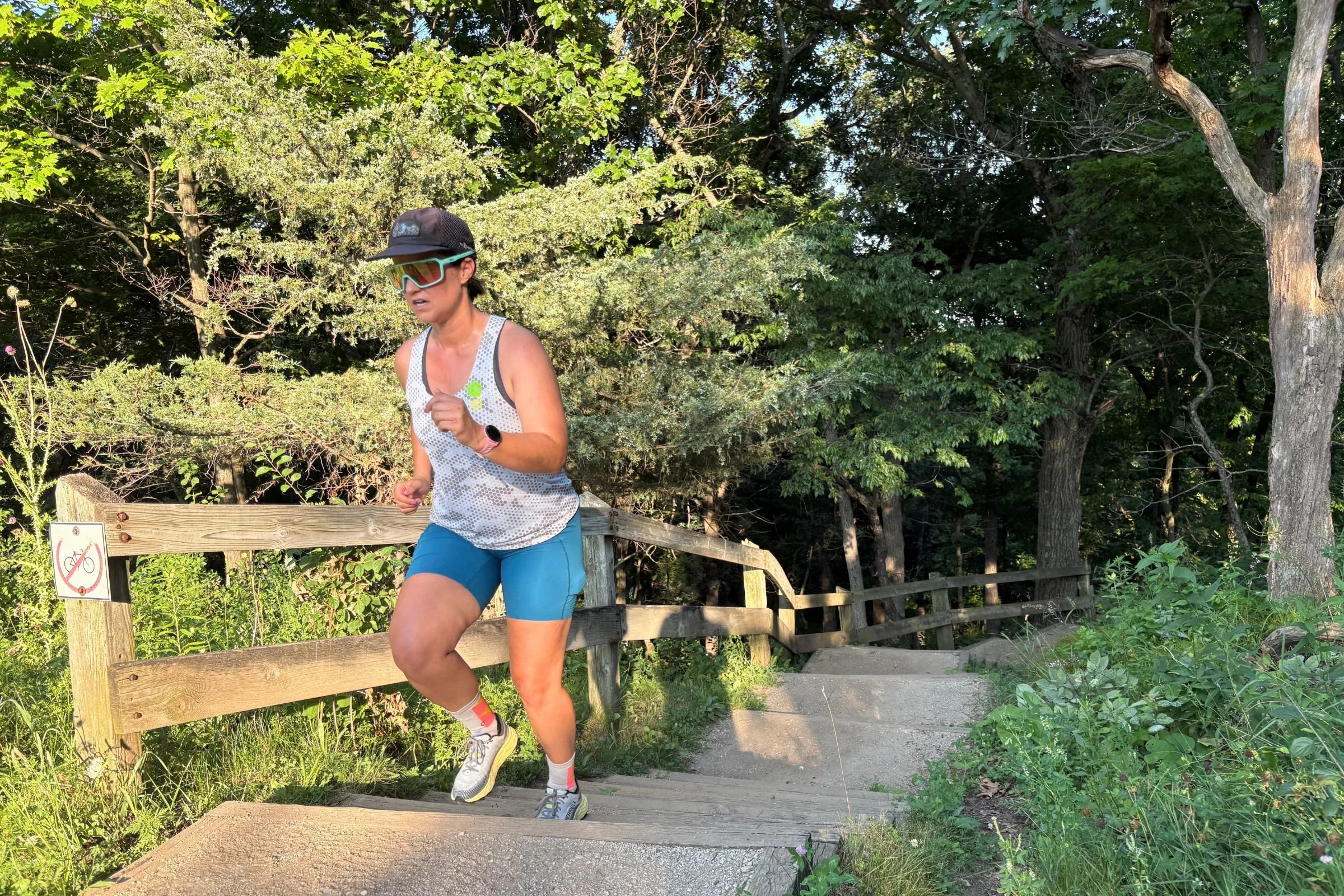   A runner wears the Janji Pace Shorts while crossing a wooden footbridge, putting the shorts’ stretch and unrestricted range of motion to use.  