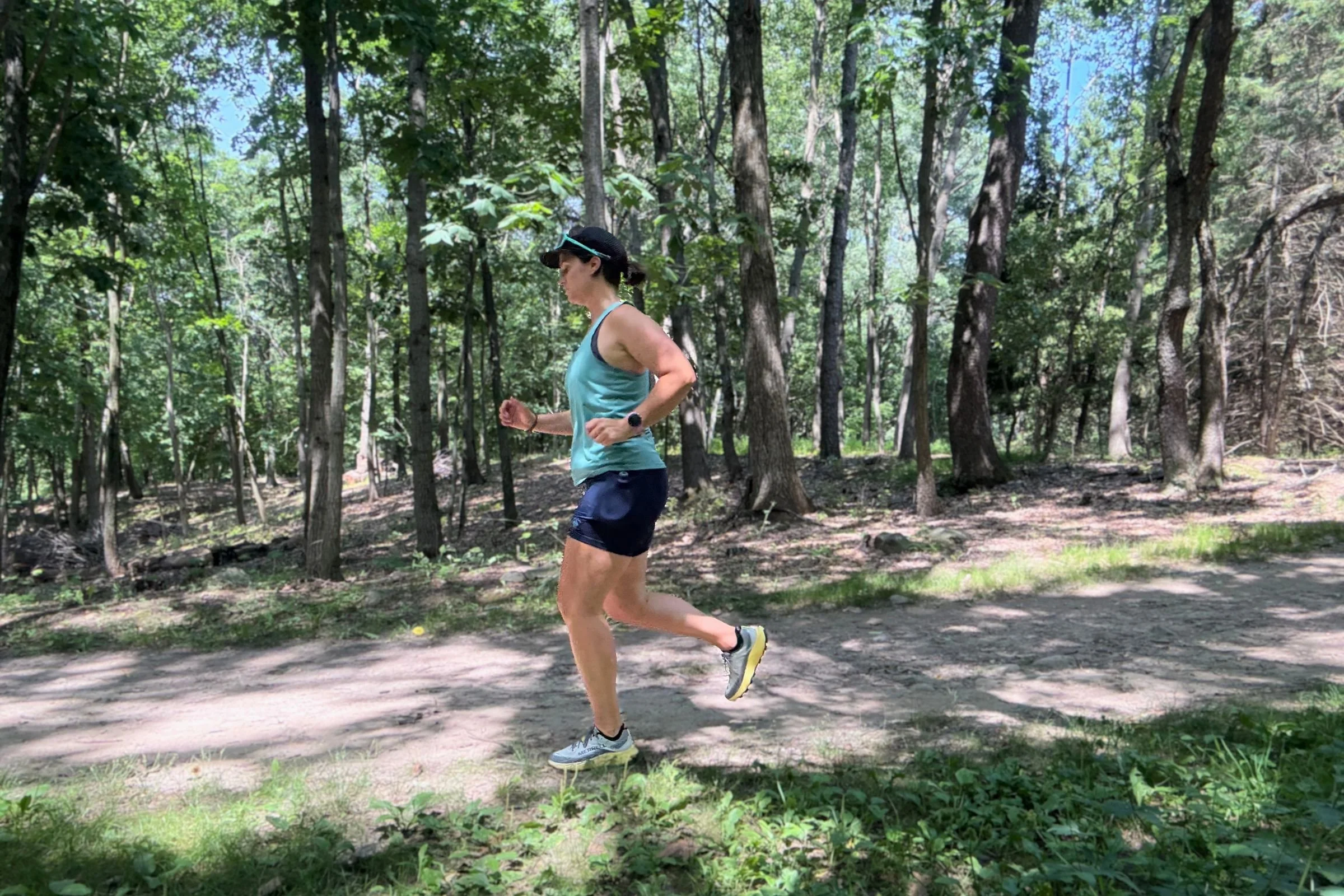   A runner wears the rabbit Leggy Smashems on a wooded trail, with the shorts’ lightweight, stretchy fabric suited to warm-weather miles.  
