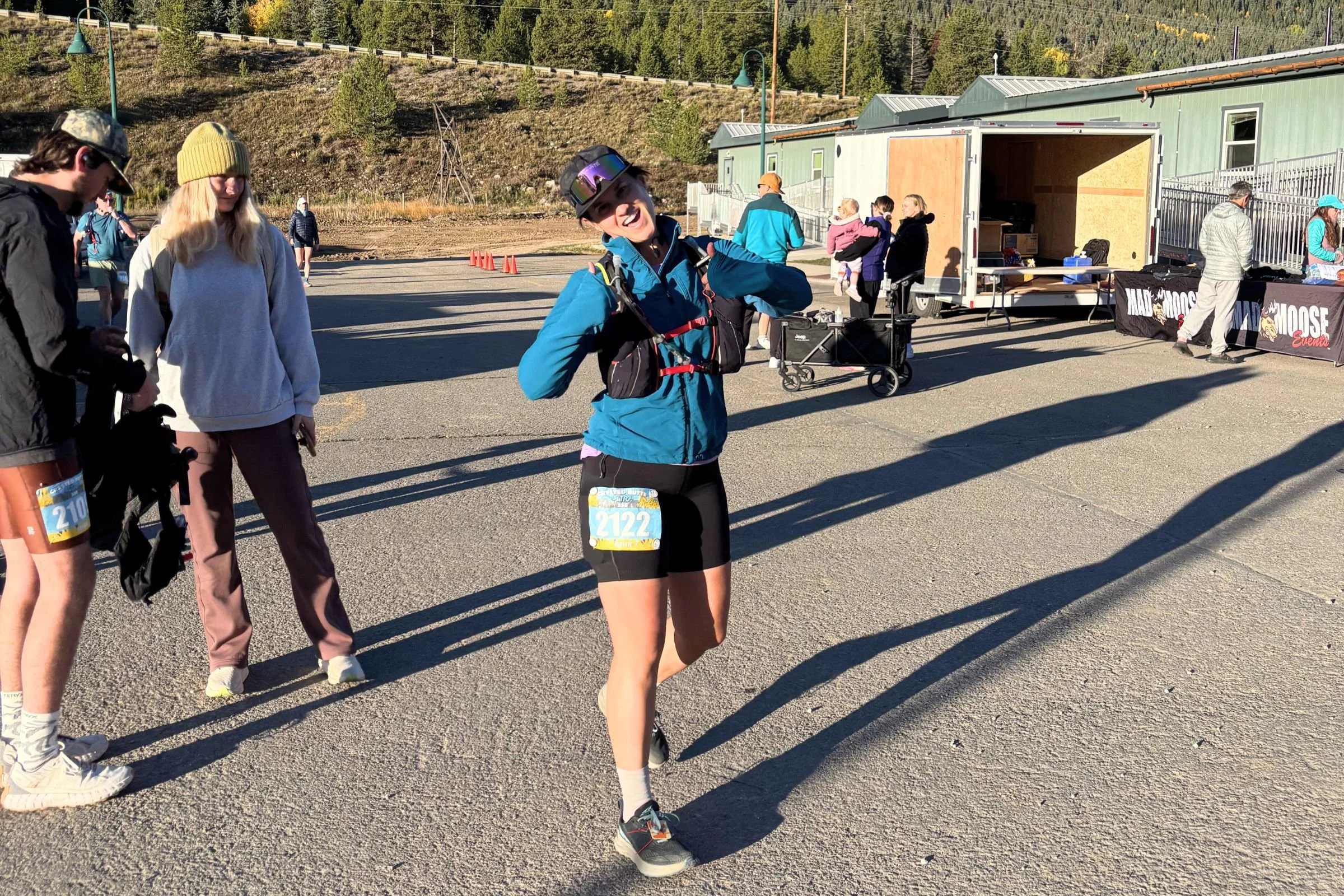   A runner wears the Arc’teryx Essent High-Rise Utility shorts during a trail outing, carrying additional gear in a running vest.  