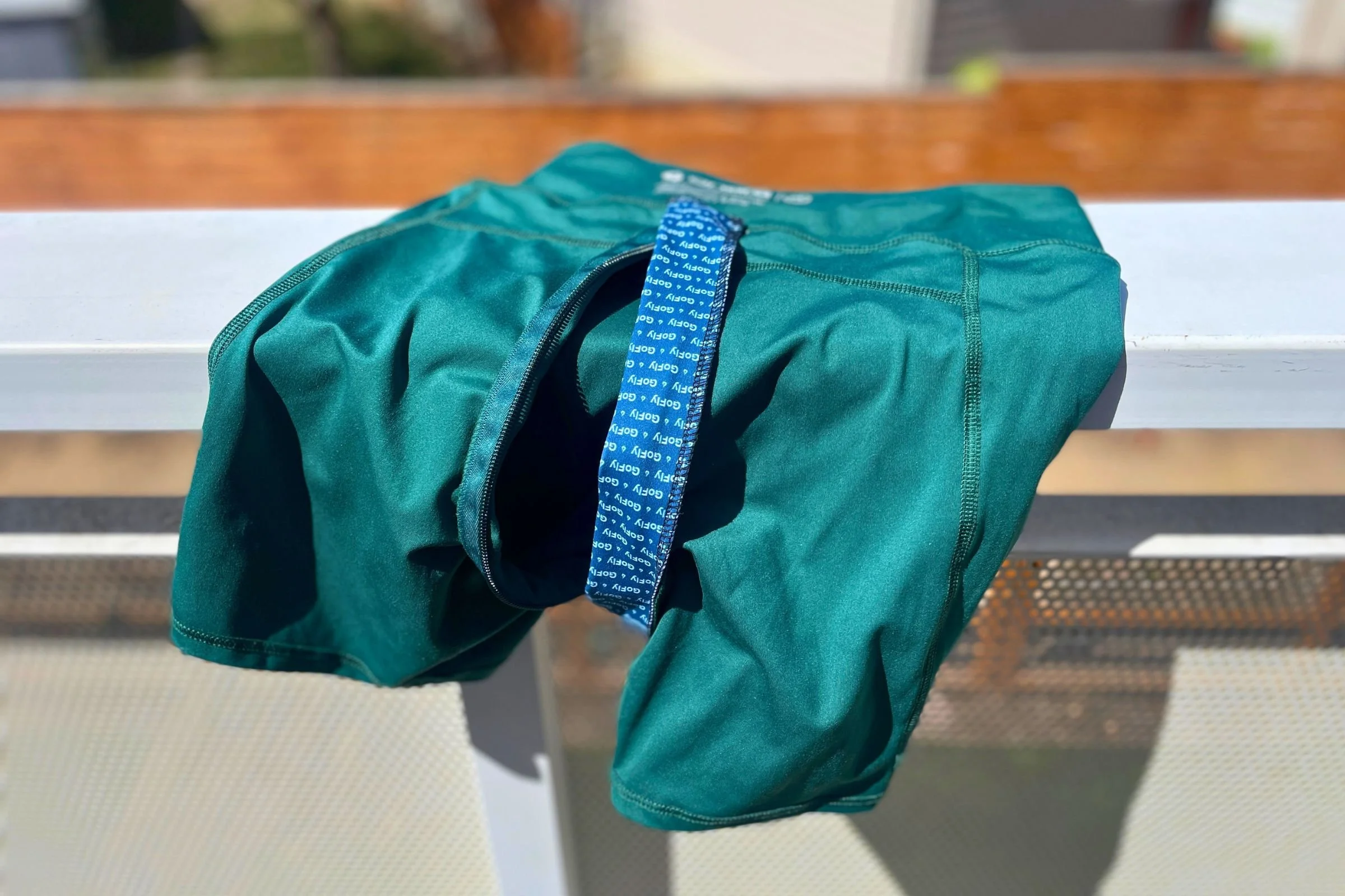   The Gnara Go Free shorts are shown from the back, with the zipper’s blue pull and rear waistband placement visible.  