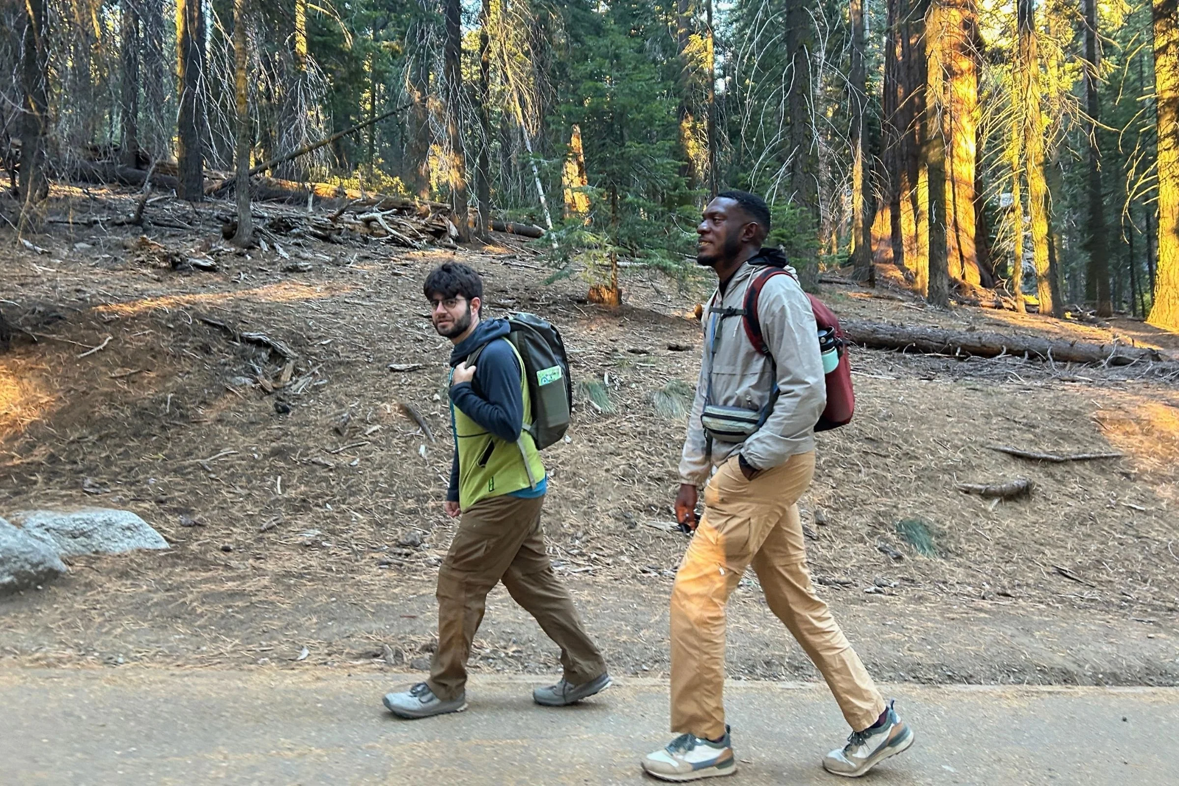   Two hikers test the Patagonia Terravia Mini Hip Pack on the trail, where its lightweight 1-liter size carries essentials without adding much bulk.  