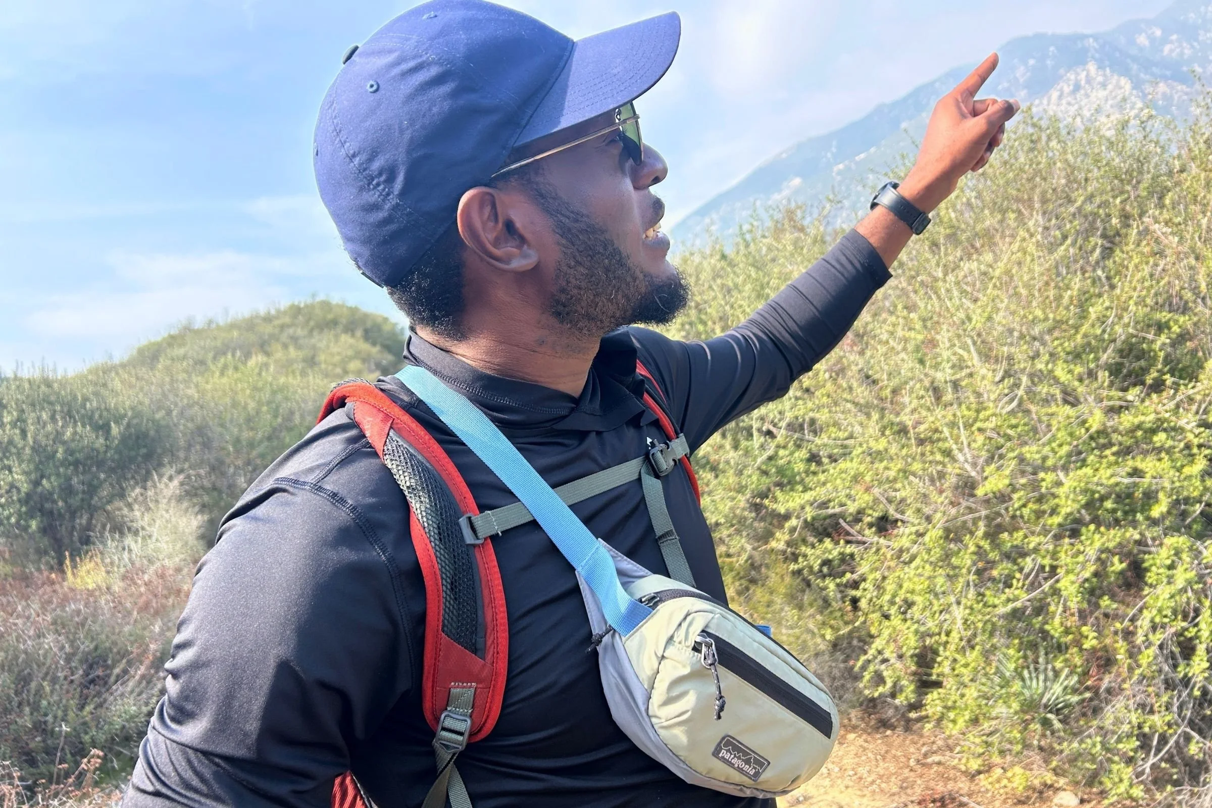   A hiker wears the Patagonia Terravia Mini Hip Pack across his chest for easy access to essentials while hiking.  