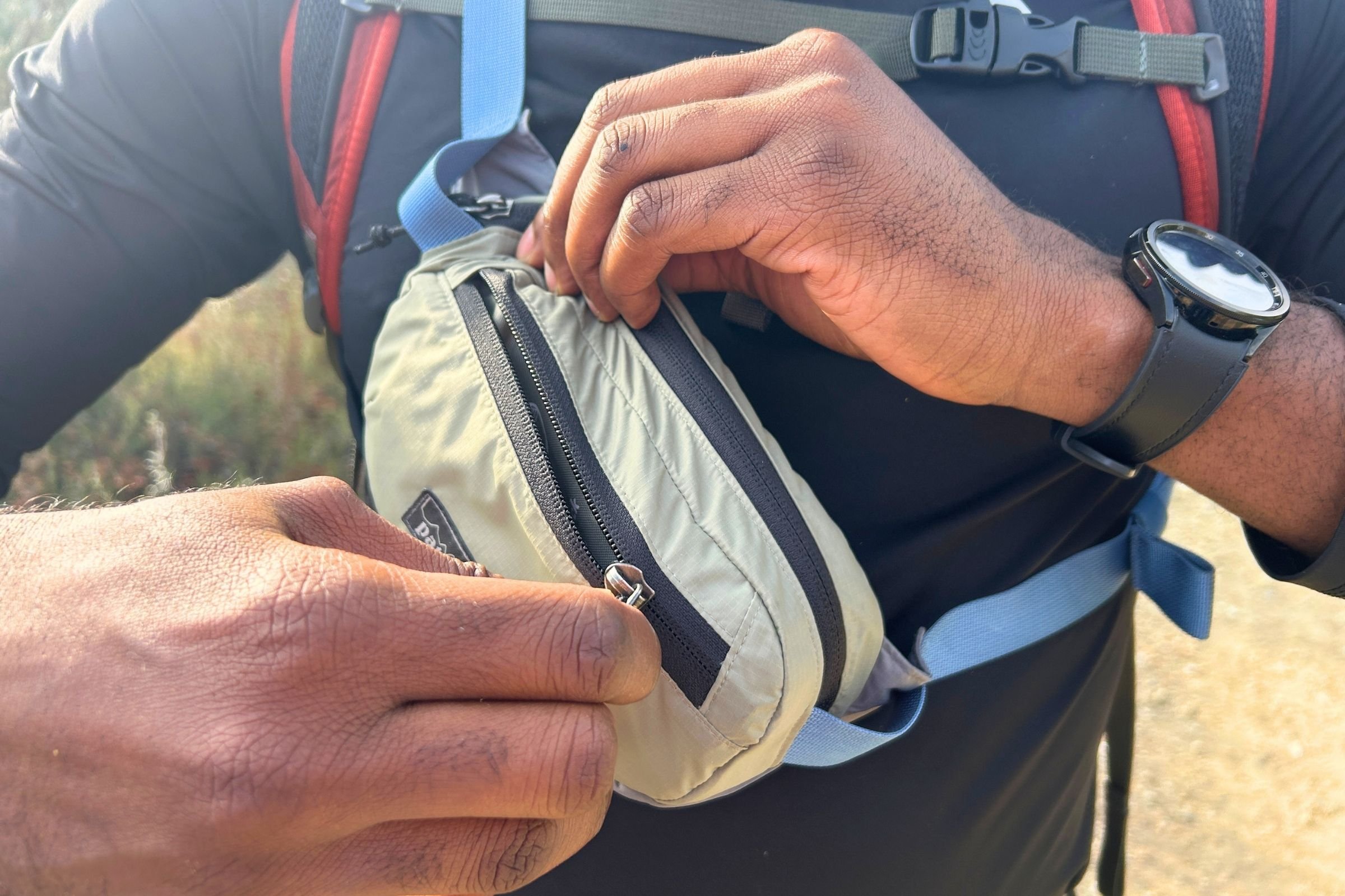   The Patagonia Terravia Mini Hip Pack has an exterior zippered pocket for keeping small hiking essentials organized and easy to reach.  
