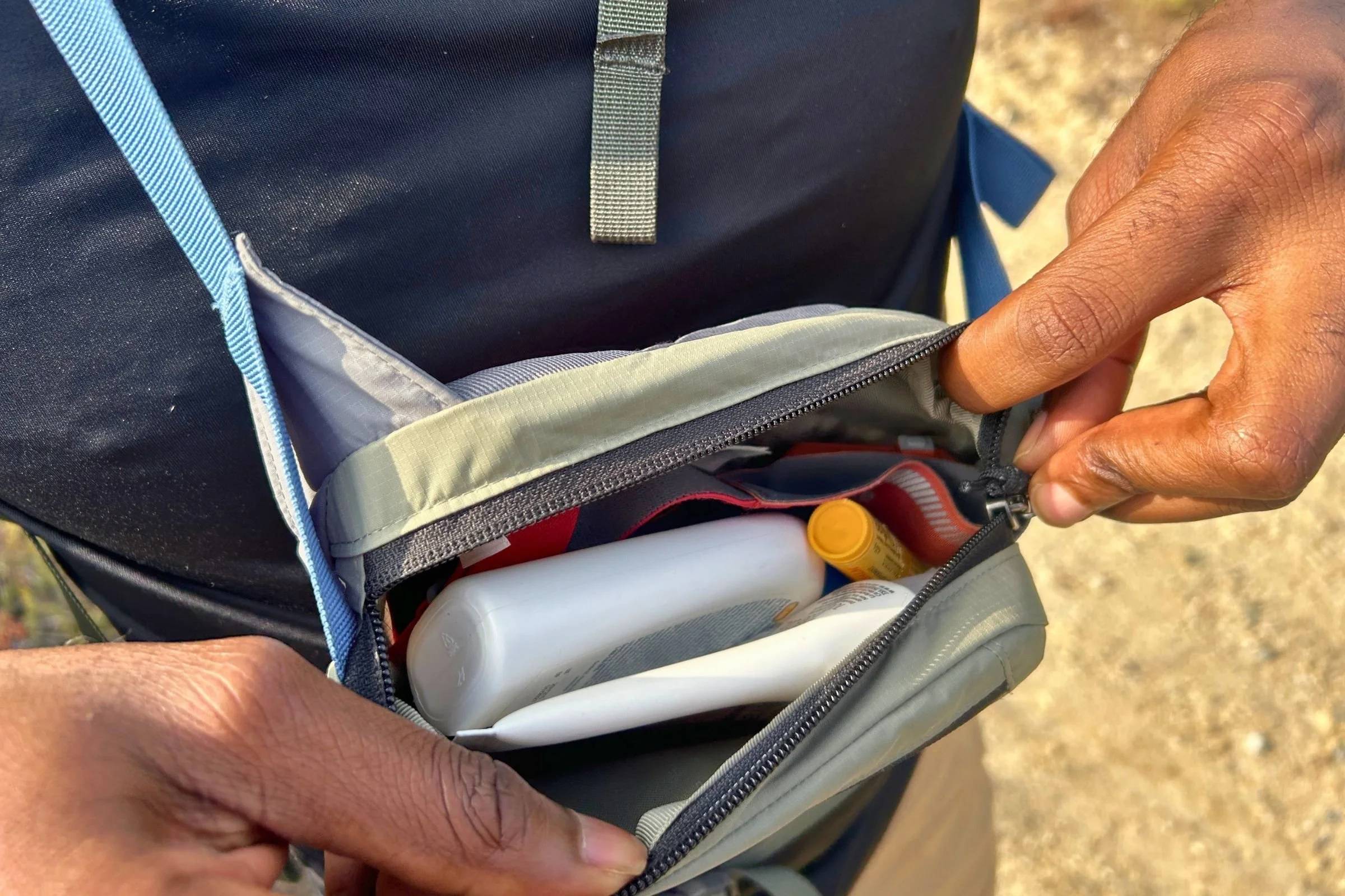   The 1-liter Patagonia Terravia Mini Hip Pack holds hiking essentials like sunscreen, a headlamp, snacks, electrolytes, a wallet, and keys.  