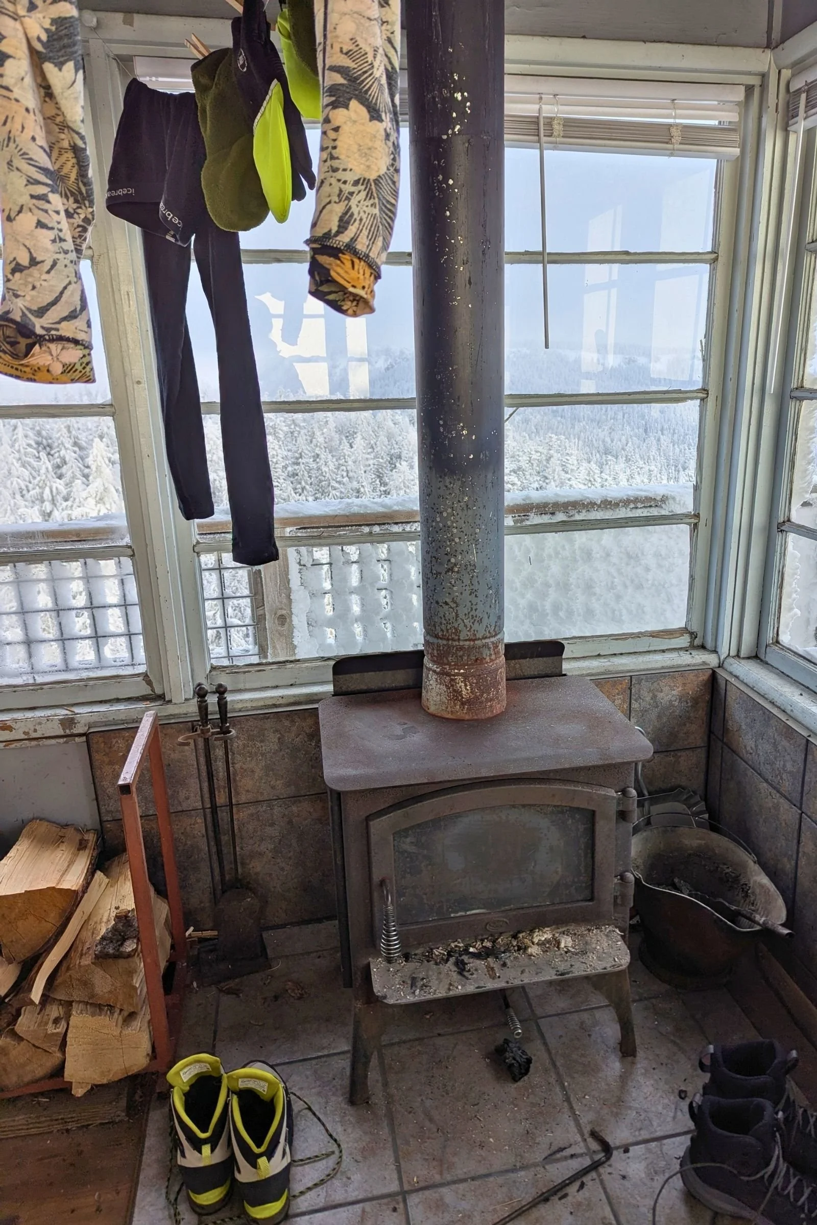   The North Face VECTIV Fastpack Insulated Mid boots dry beside a wood stove after a day in the snow, part of our winter testing in conditions ranging from cold and snowy to warm and rainy.  