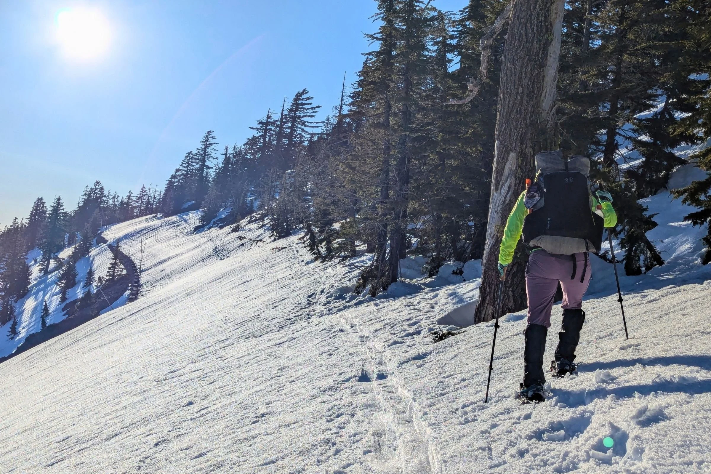   A hiker snowshoes uphill in The North Face VECTIV Fastpack Insulated Mid, a lightweight winter boot designed to stay comfortable over long miles.  