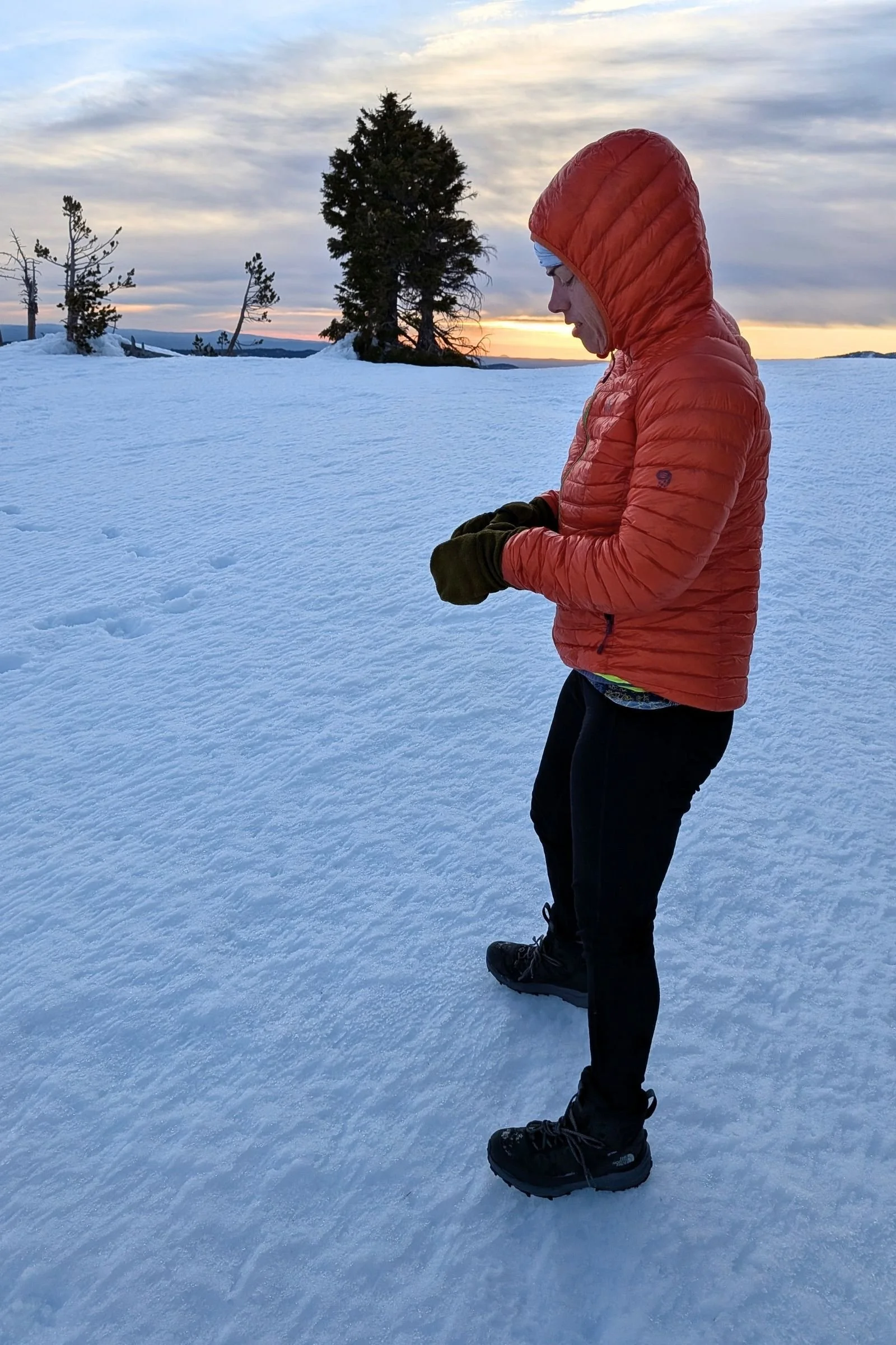   A hiker wears The North Face VECTIV Fastpack Insulated Mid on packed snow, where the lightweight design feels more like a trail shoe than a traditional winter boot.  