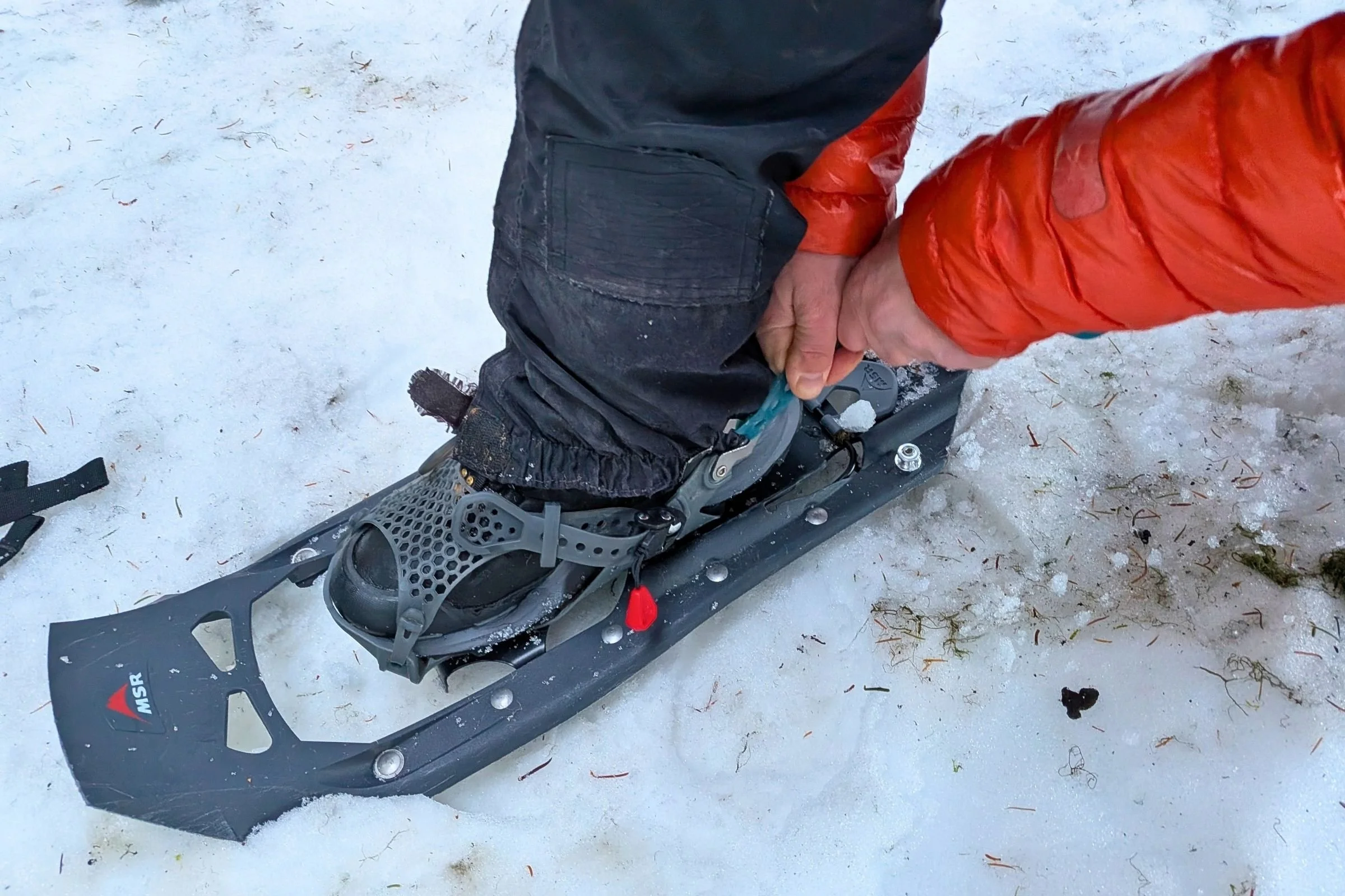   A close-up of The North Face VECTIV Fastpack Insulated Mid in a snowshoe shows how the heel design helps hold the rear strap securely in place.  