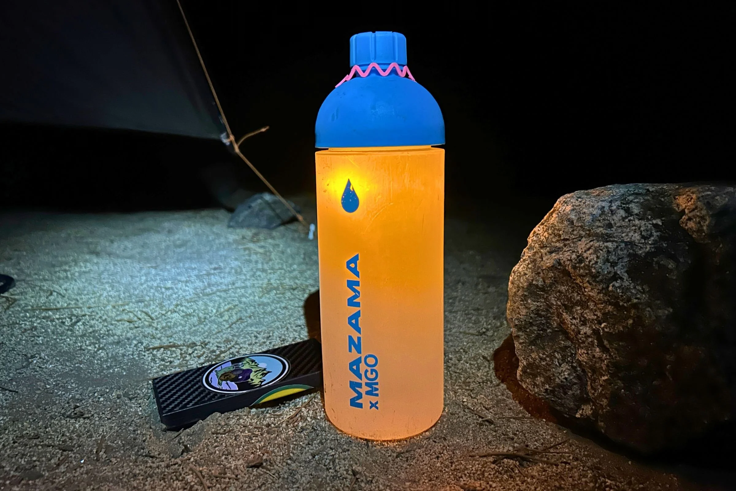   The Alpenblow Lux slides onto a water bottle, which diffuses its built-in light into a soft, 360-degree glow around camp.  