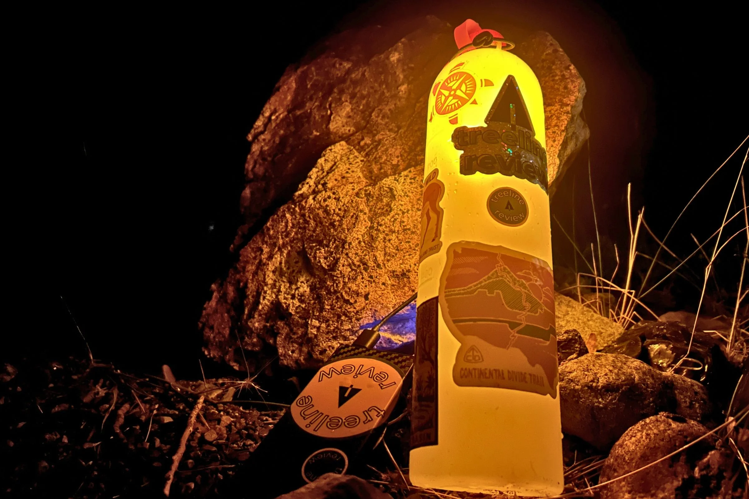   The Alpenblow Lux uses a standard water bottle as a diffuser for its warm lantern light, giving this tiny pad inflator another useful job at camp.  