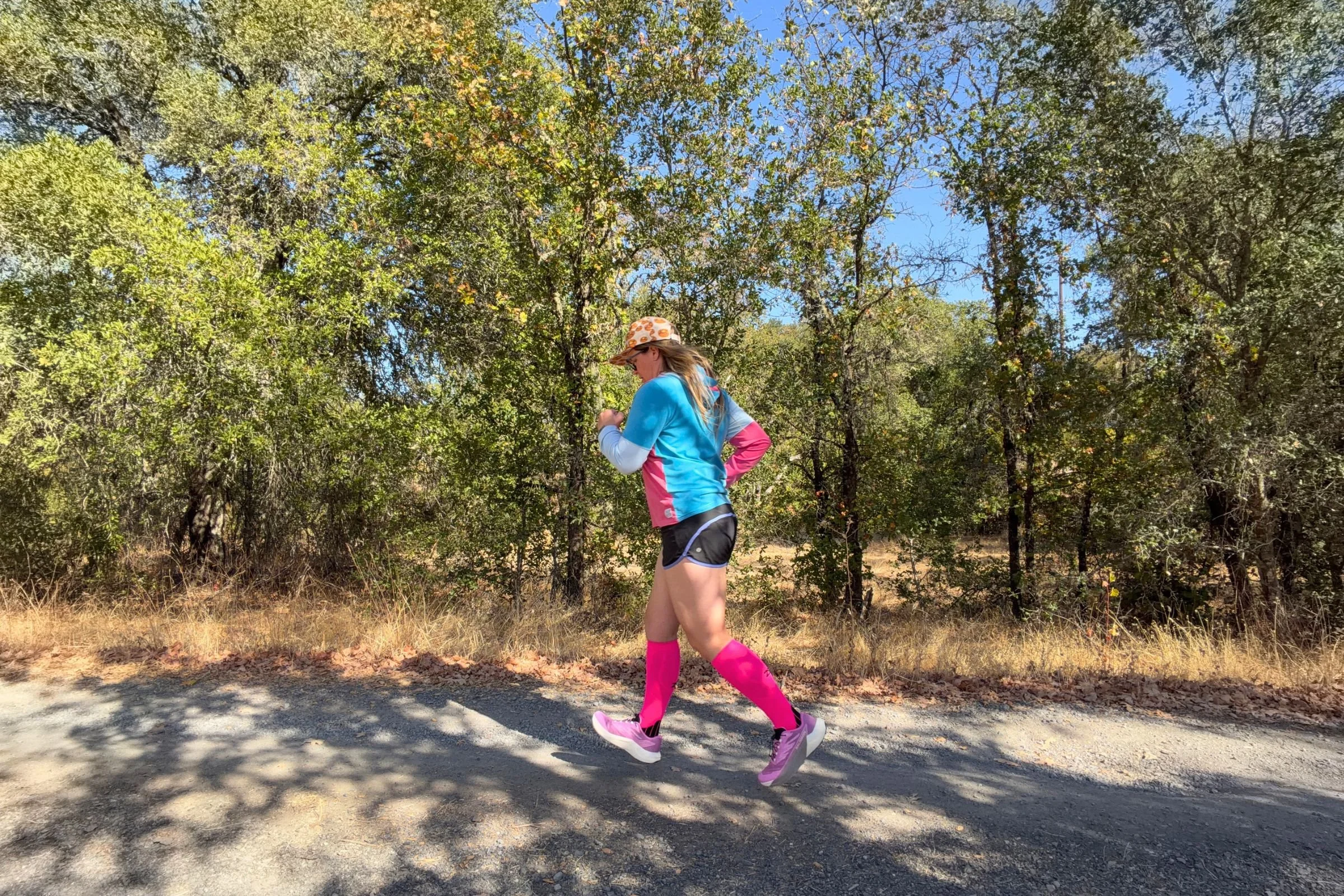   The Zensah Tech+ Graduated Compression Socks provide comfortable calf support as a runner makes her way along a dirt trail, with smooth, snag-resistant fabric suited to rugged terrain.  