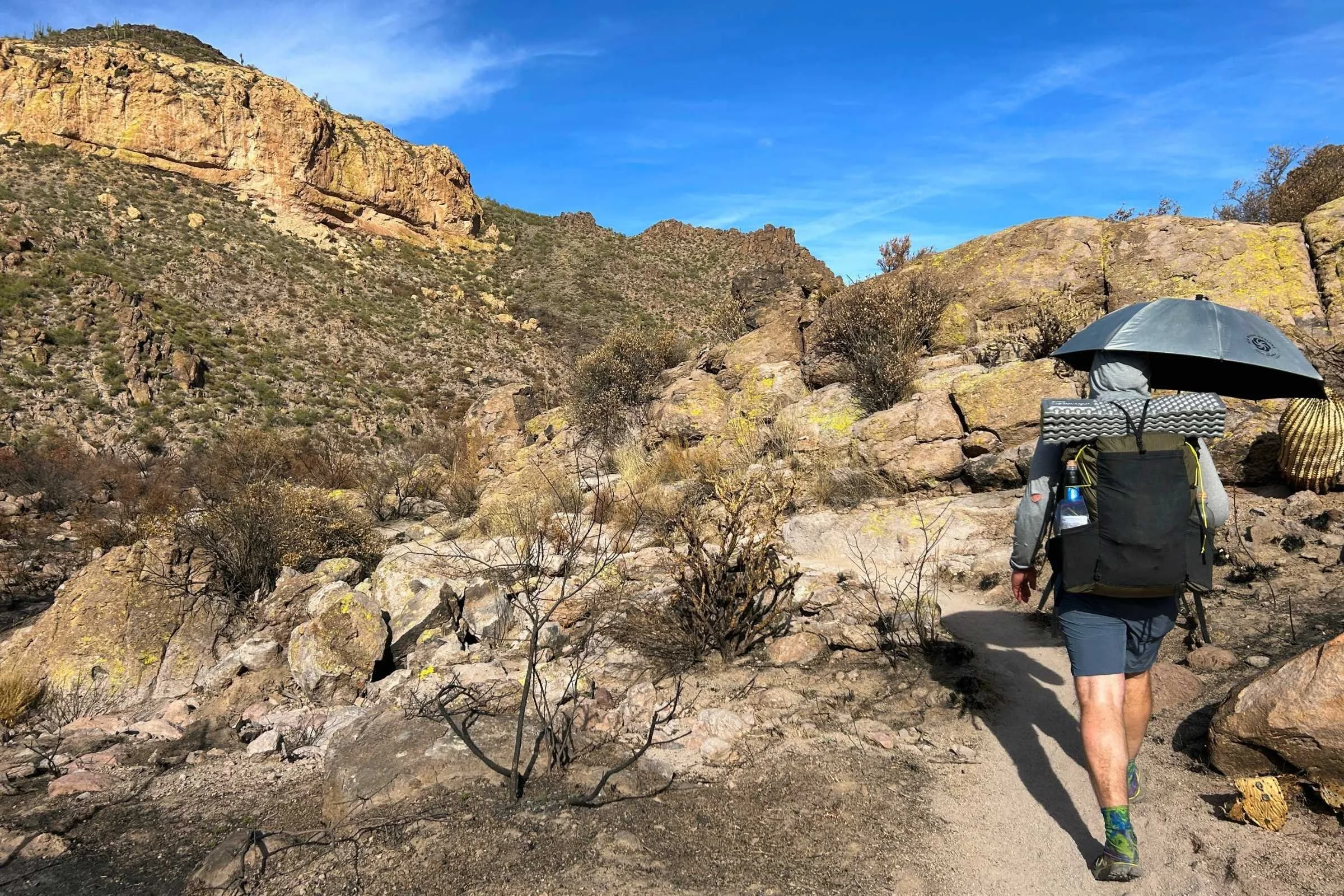 Hiker with the SMD Silver Shadow hiking umbrella on the Grand Enchantment Trail in Arizona.