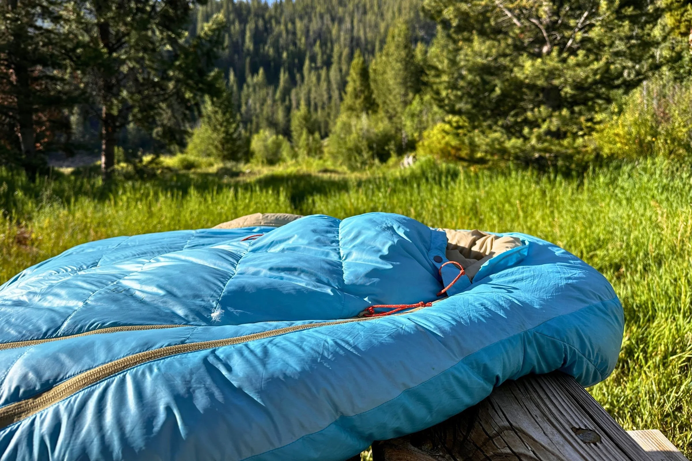 Therm-a-Rest Boost 650 is a blue sleeping bag laying on its side zipped close.