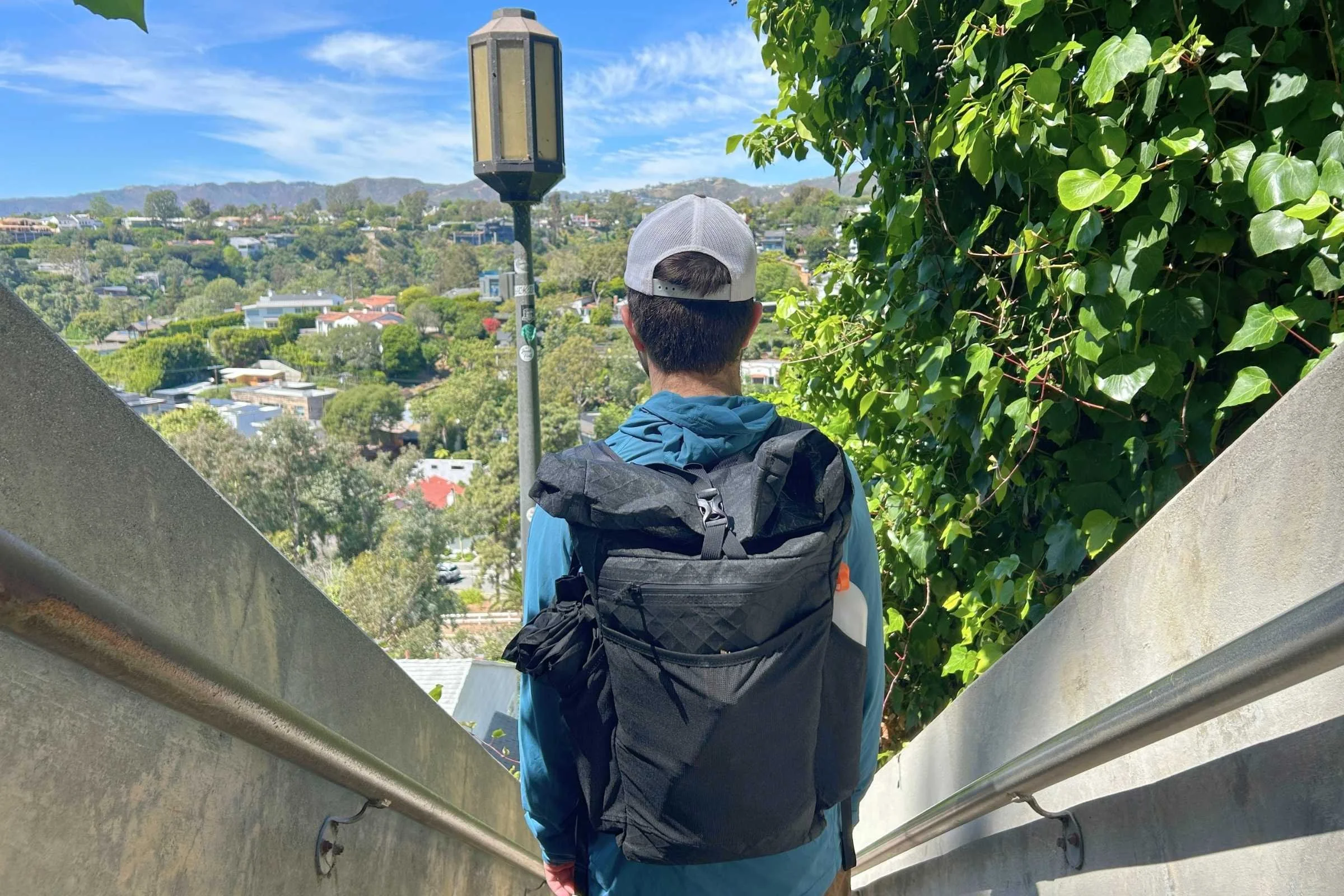 person wearing the ula ultra node 20l backpack walking down a staircase