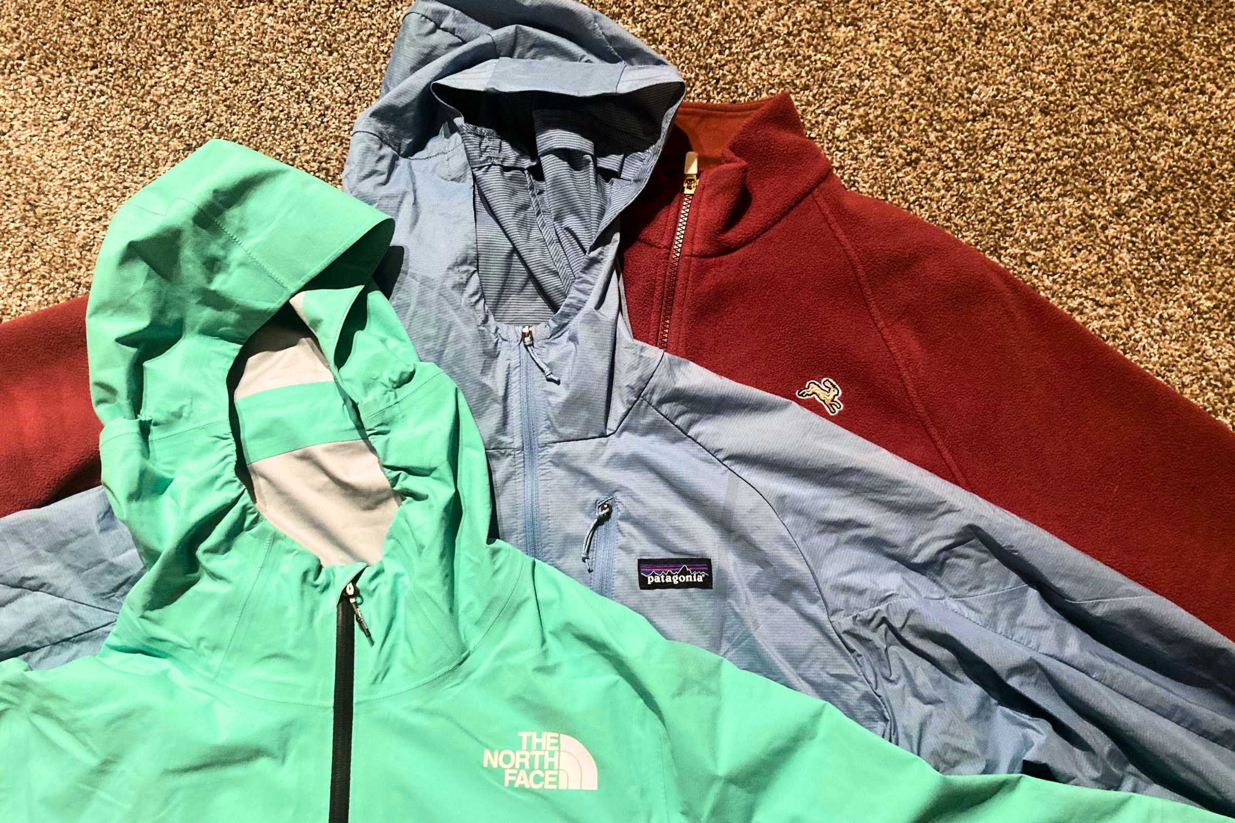 Left to right: Polyester rain shell, Nylon wind jacket, Polartec Fleece insulation layer. All excel in specific conditions but can also be layered as shown for bitter cold runs.  Photo by Trey French