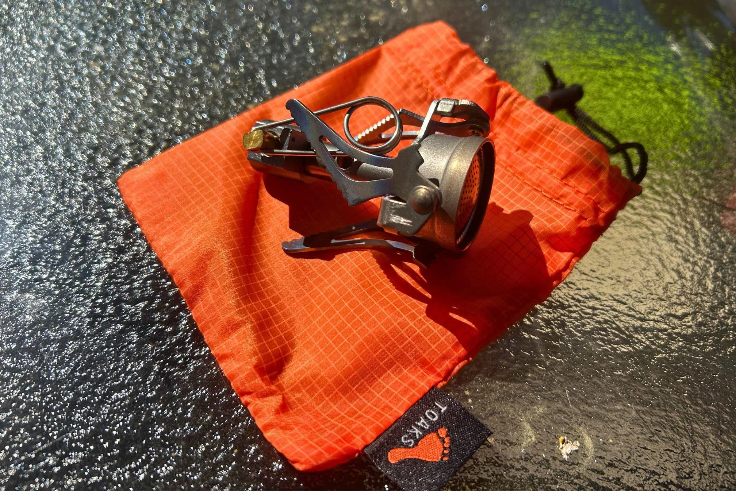 Toaks stove folded up on top of carry case