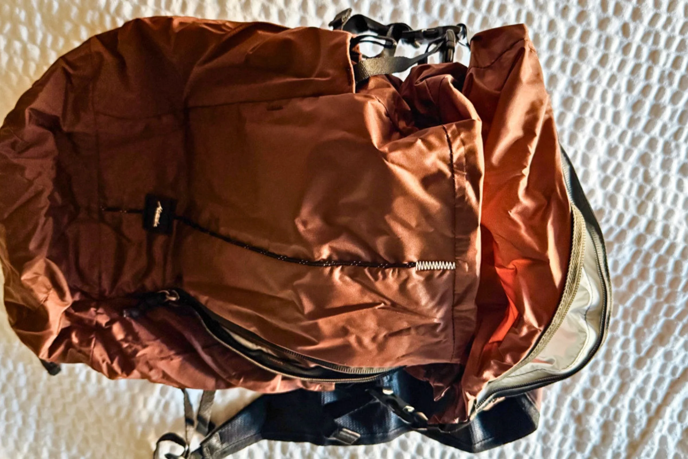 Matador 18L Waterproof Packable Backpack laid flat with its roll-top opening unzipped.