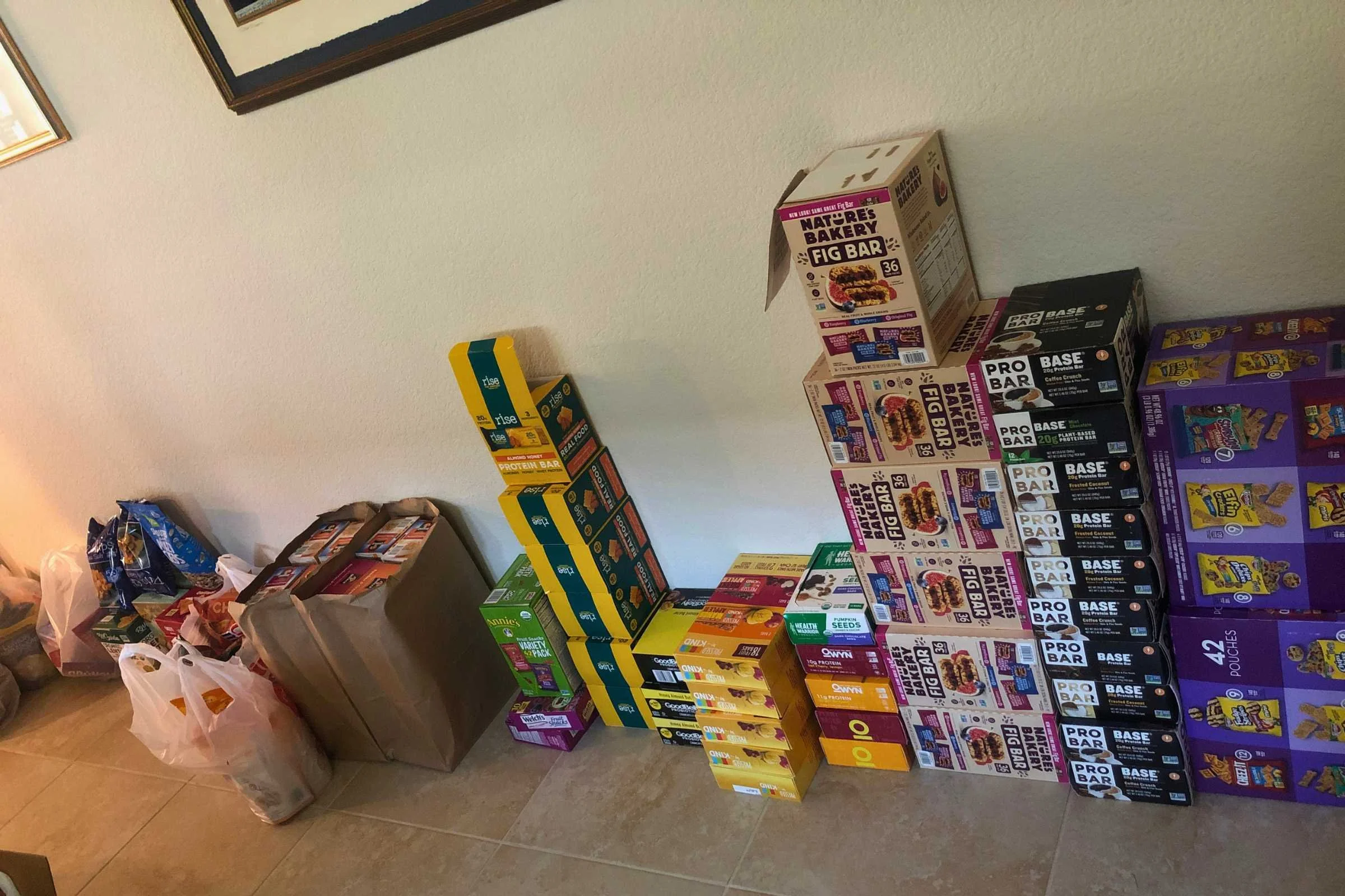 several boxes of protein and energy bars stacked against the wall