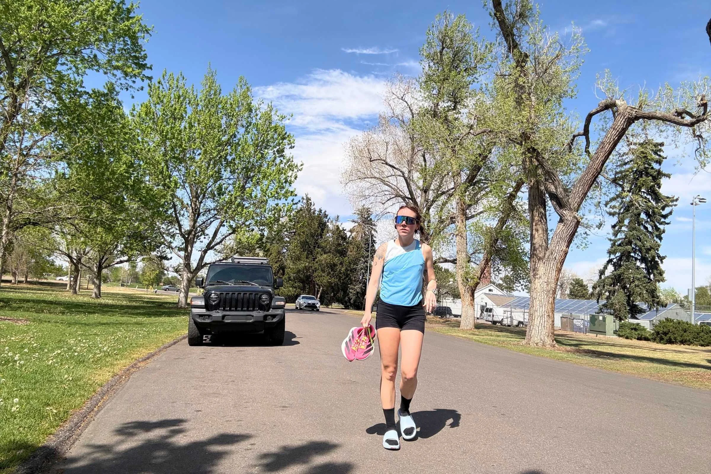 Norda 008 Recovery Slides: A woman in a blue shirt and shorts walking down the street.