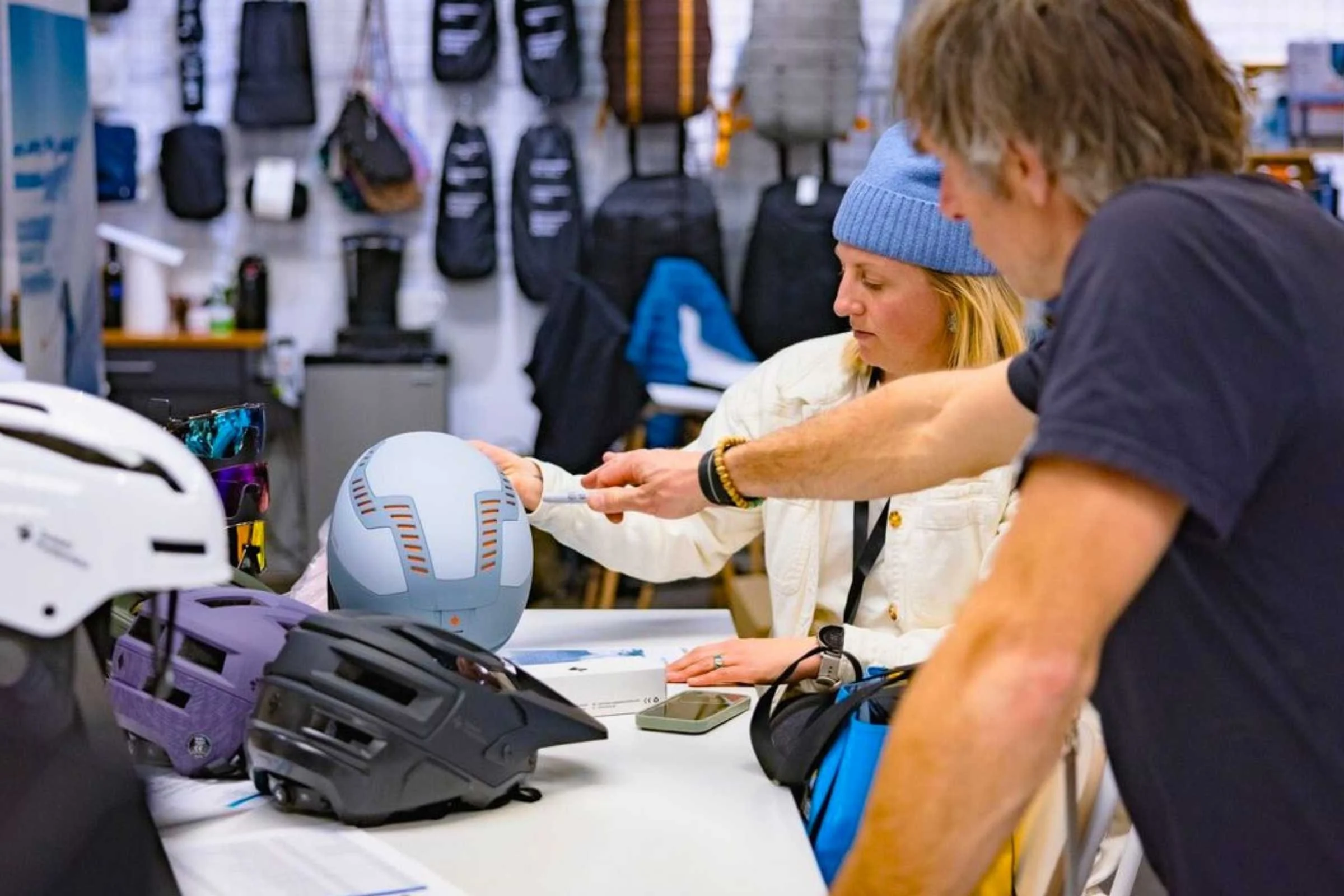 Outdoor Market Alliance Winter 2026 attendees checking out new ski helmets