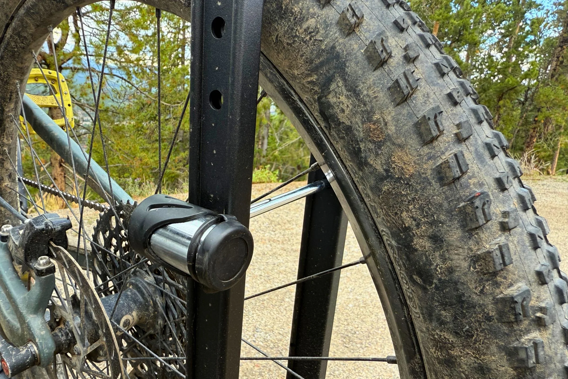 Close-up of a bicycle wheel secured in the wheel-lock mechanism of a Hollywood Racks CrossTrack Hitch Bike Rack.
