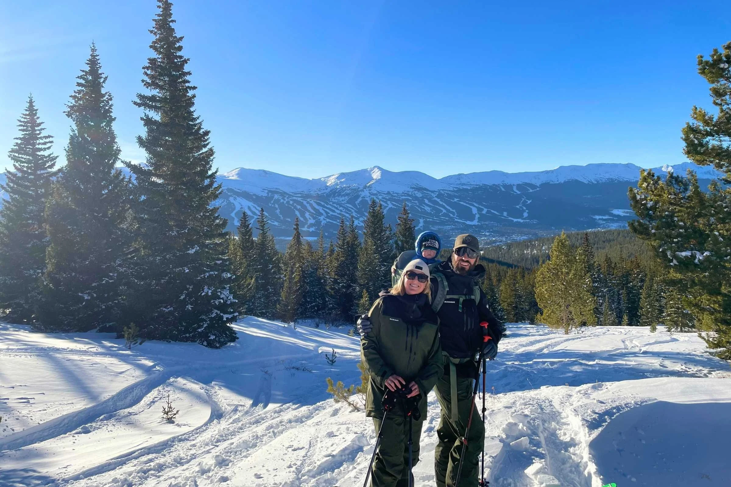 Author ski touring wearing Mammut Haldigrat HS jacket while ski touring with her family