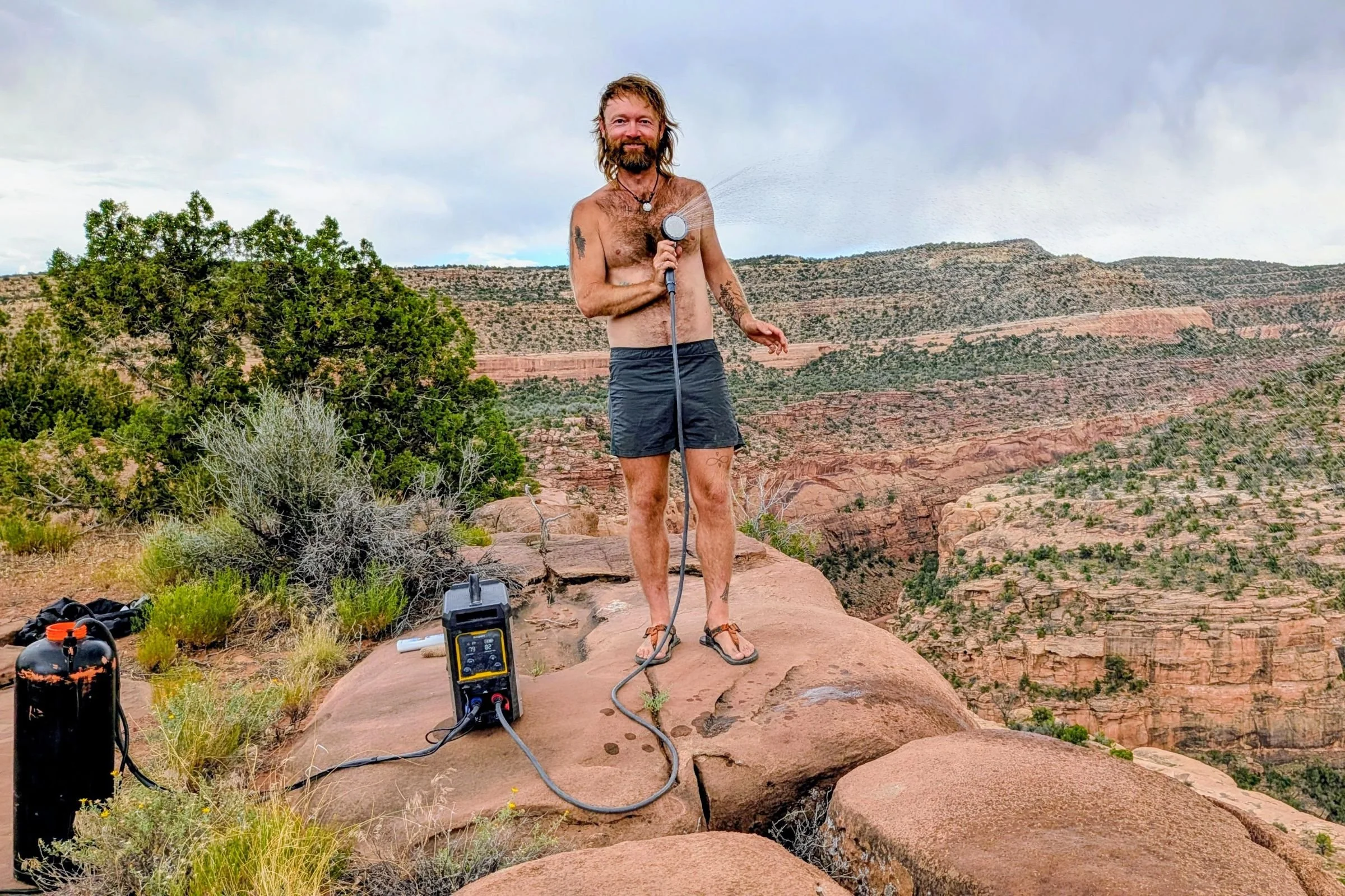 The author taking a shower on the edge of a ridge in Utah.