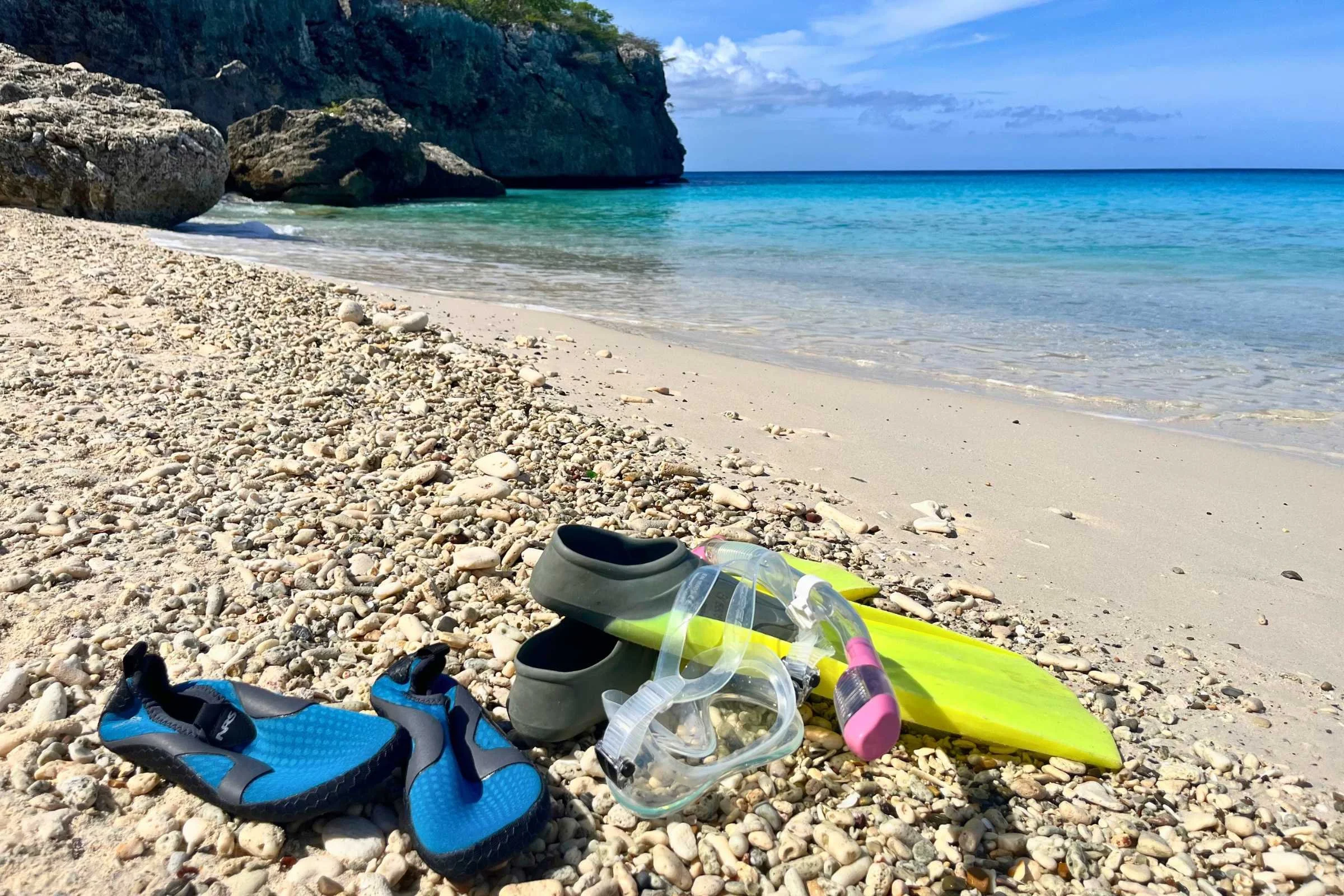 Walking on sandy beach in water shoes