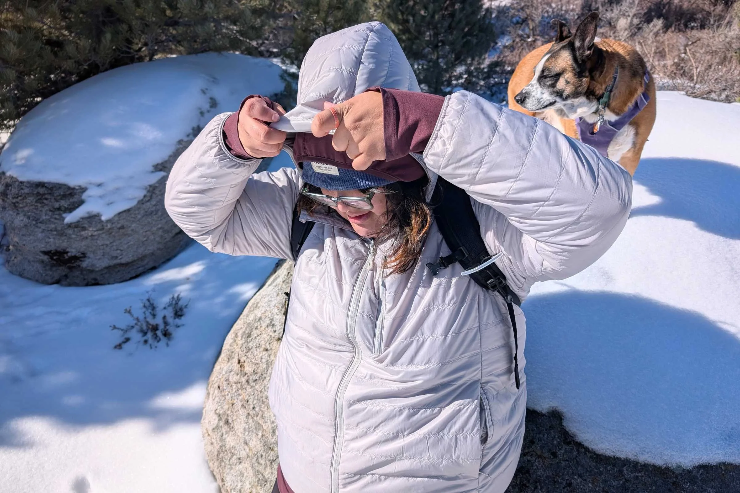 Pulling on the hood of the REI Co-Op Microtrek Hoodie.