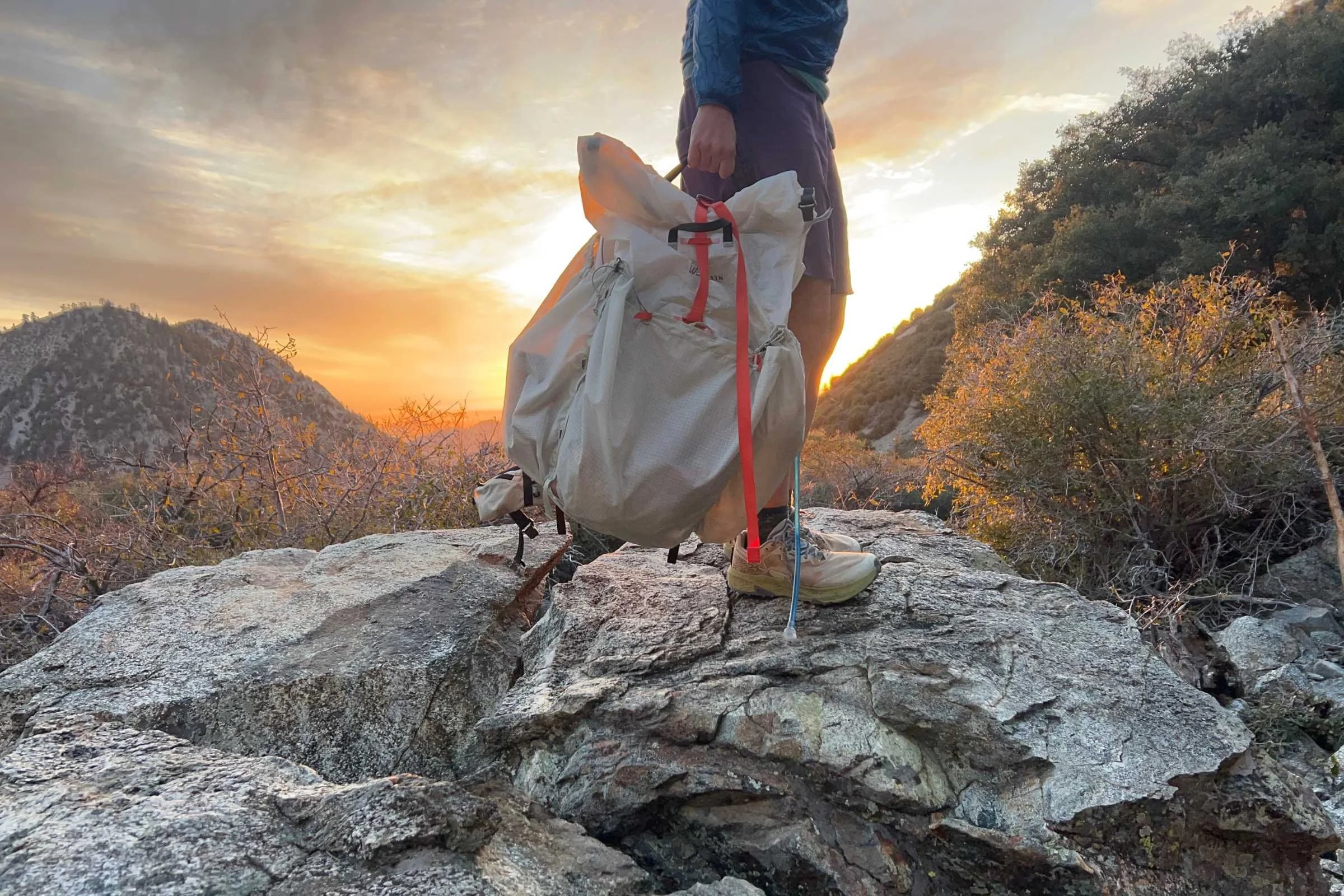The Mountain Hardwear Alakazam backpack in the mountains at sunset