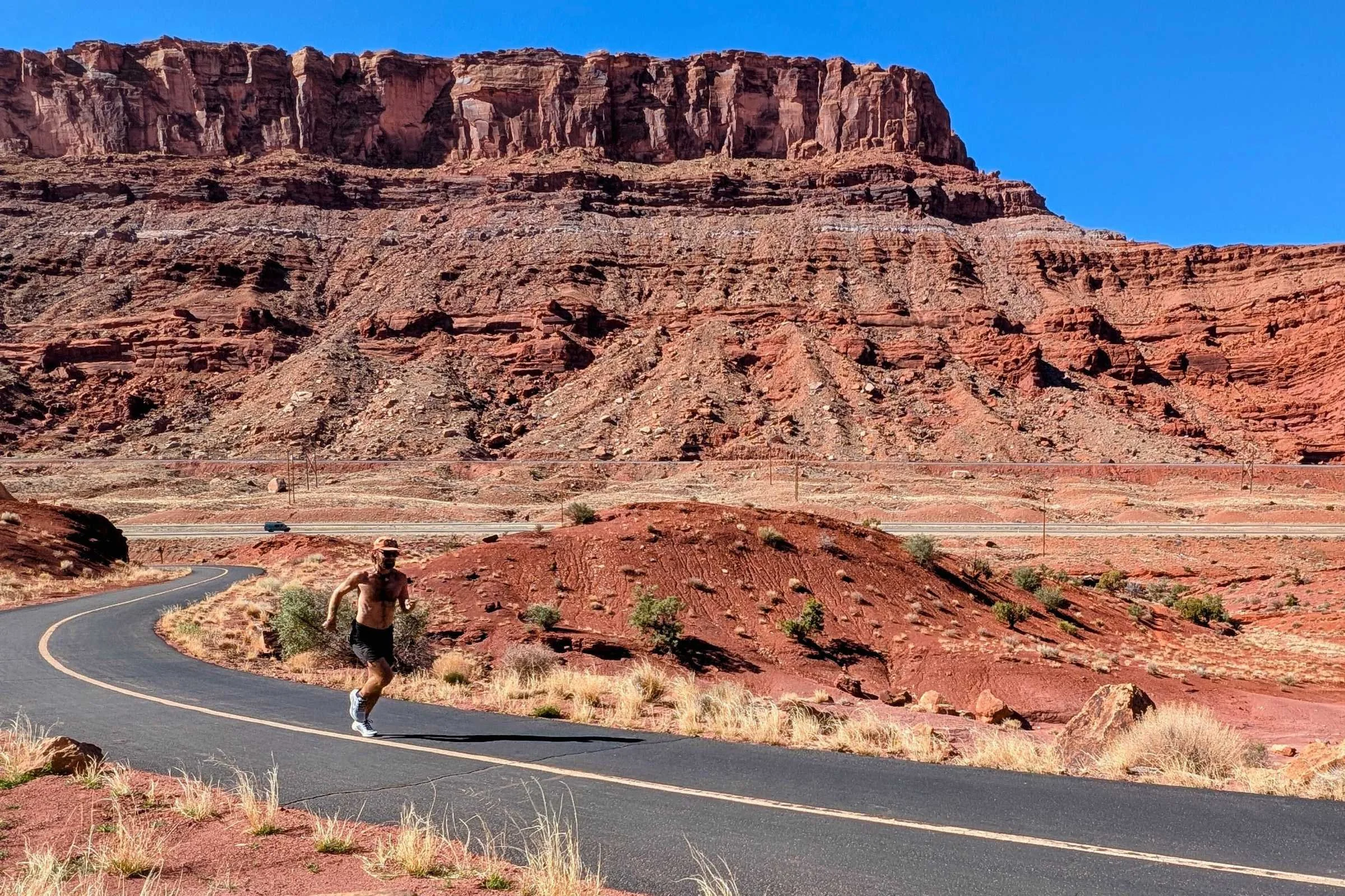 Man running on desert road in Nike Pegasus